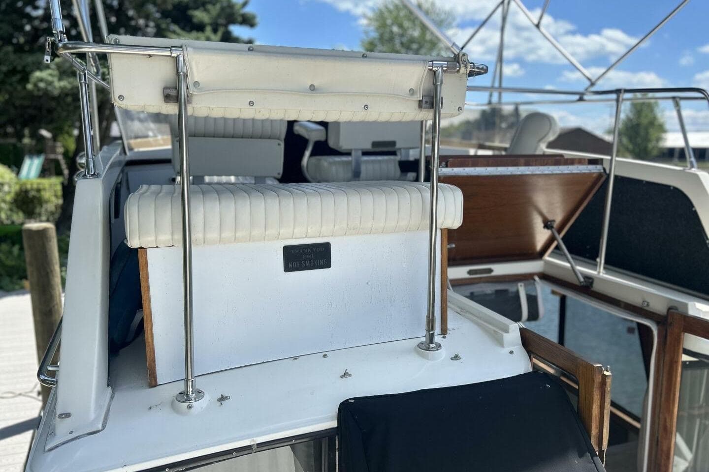 1985 Carver 3207 Aft Cabin boat with white seating and open deck view.