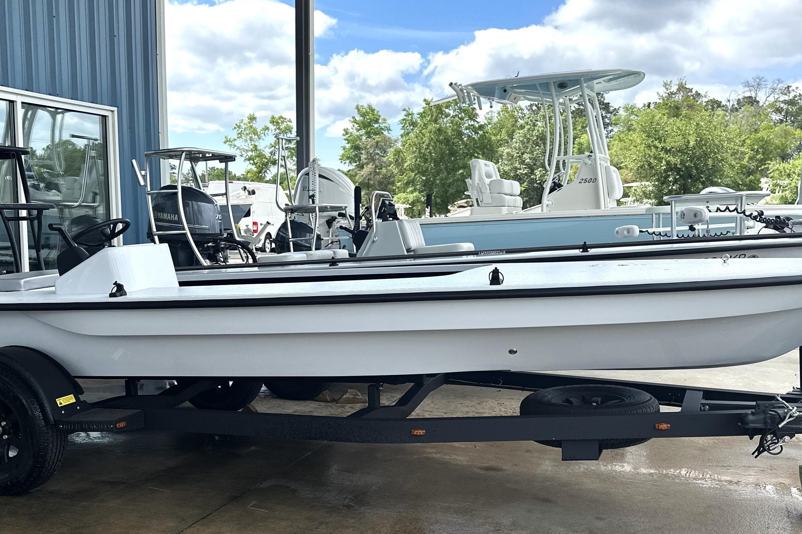 2026 Chittum Skiffs 18 Challenger 2.0 boat on trailer, parked outdoors.