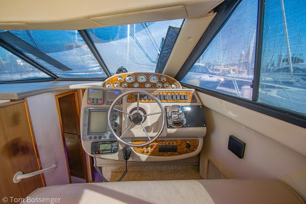 2001 Bayliner 3788 Command Bridge Motoryacht helm with steering wheel and navigation instruments.