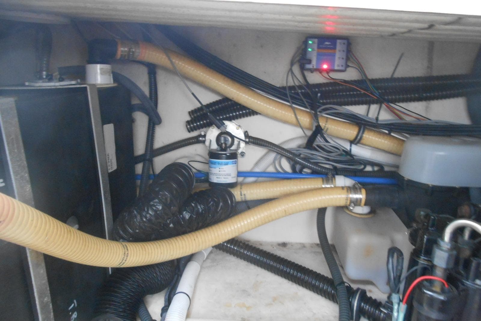 Engine compartment of a 2004 Formula 27 Performance Cruiser with visible hoses and wiring.