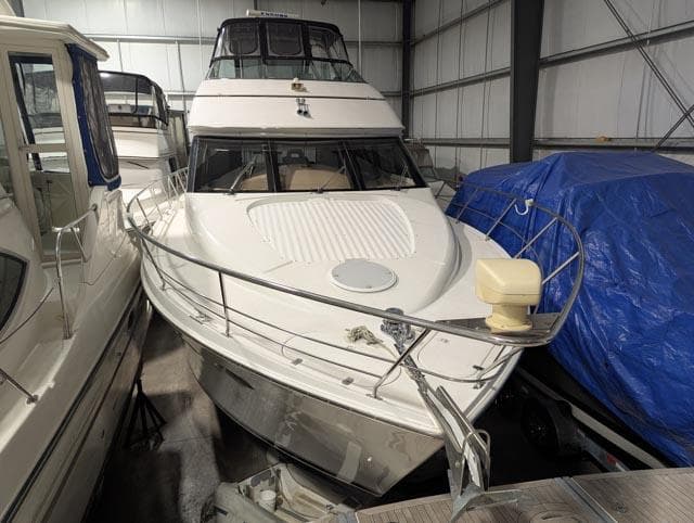 1999 Carver 530 Voyager Pilothouse yacht in storage, front view, indoor setting.