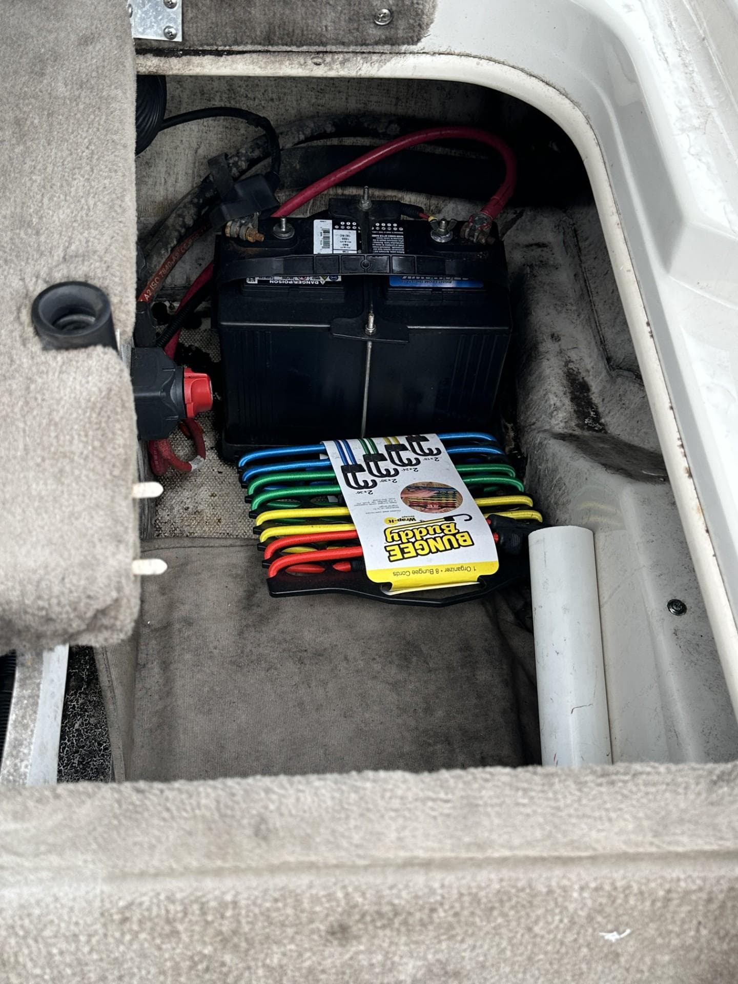 Battery compartment of a 2005 Sea Ray 185 Sport boat with colorful wiring.