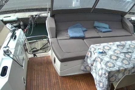 2016 Prestige 550 yacht deck with seating, table, and folded towels.
