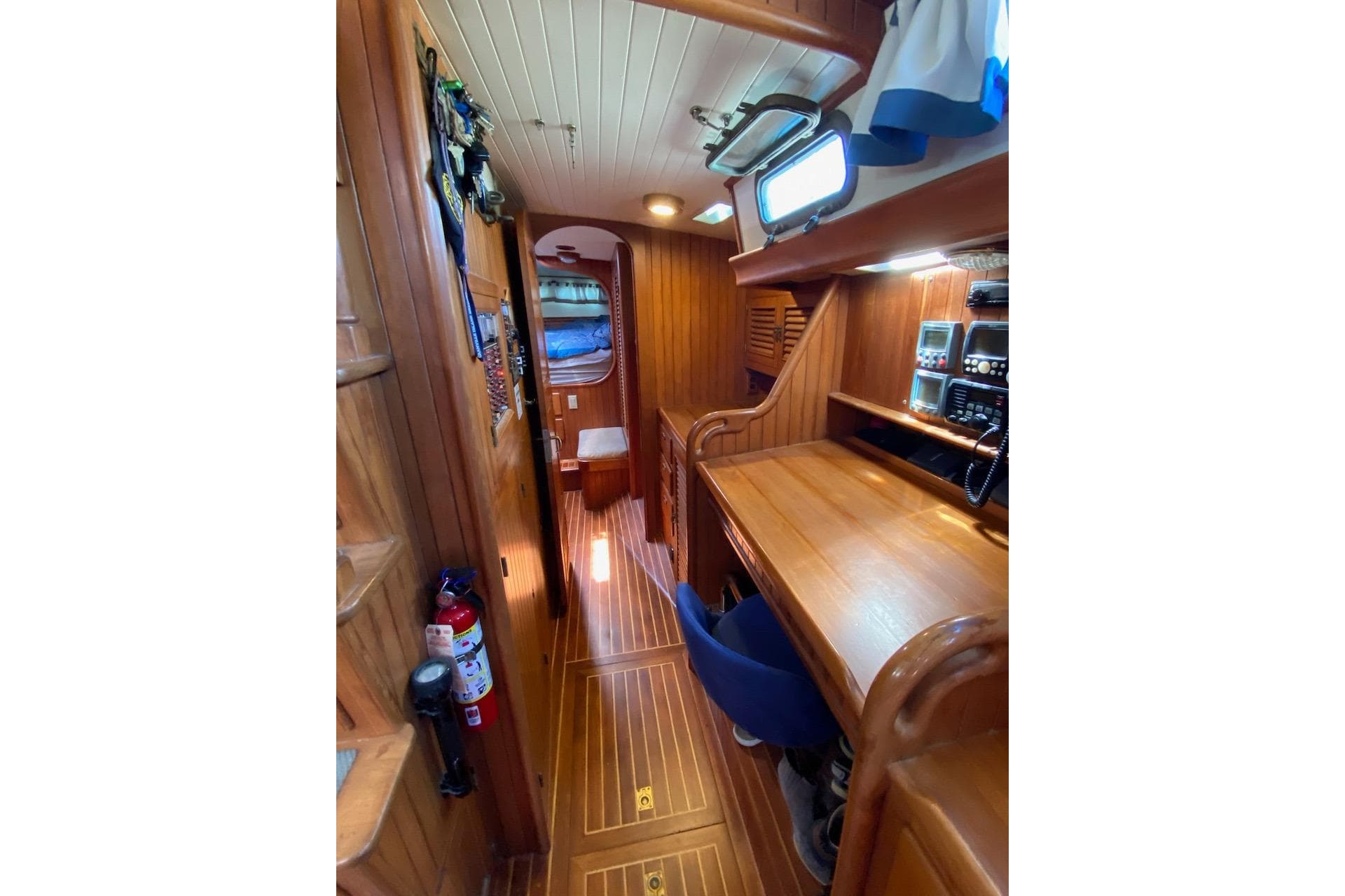 Interior of 1985 Liberty 458 yacht with wooden furnishings and navigation equipment.