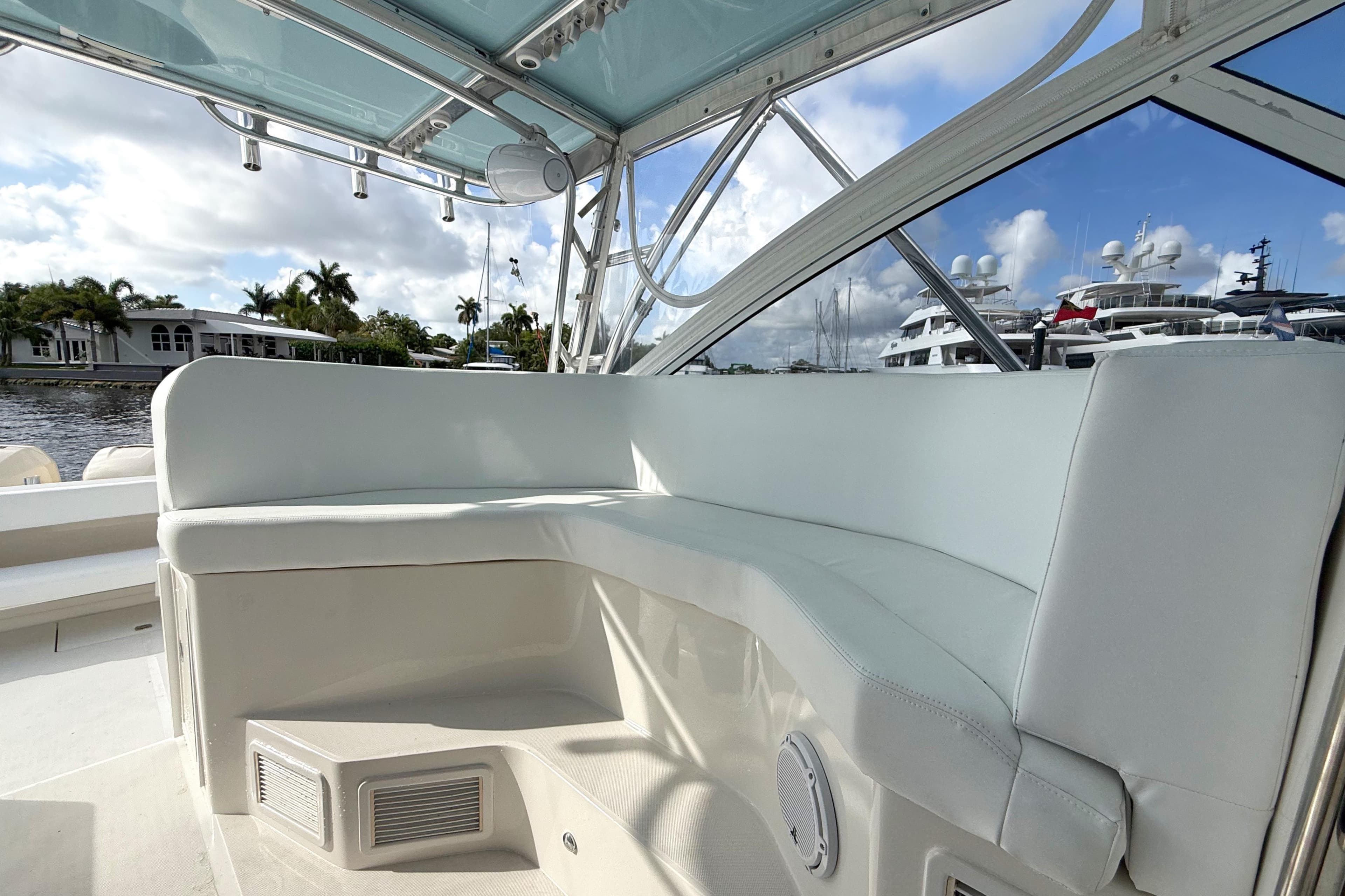 2009 Jupiter 39 Express boat interior with white seating and marina view.