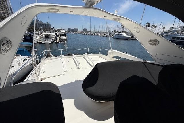 2001 Bayliner 5288 Pilot House Motoryacht docked in a marina, with spacious deck view.