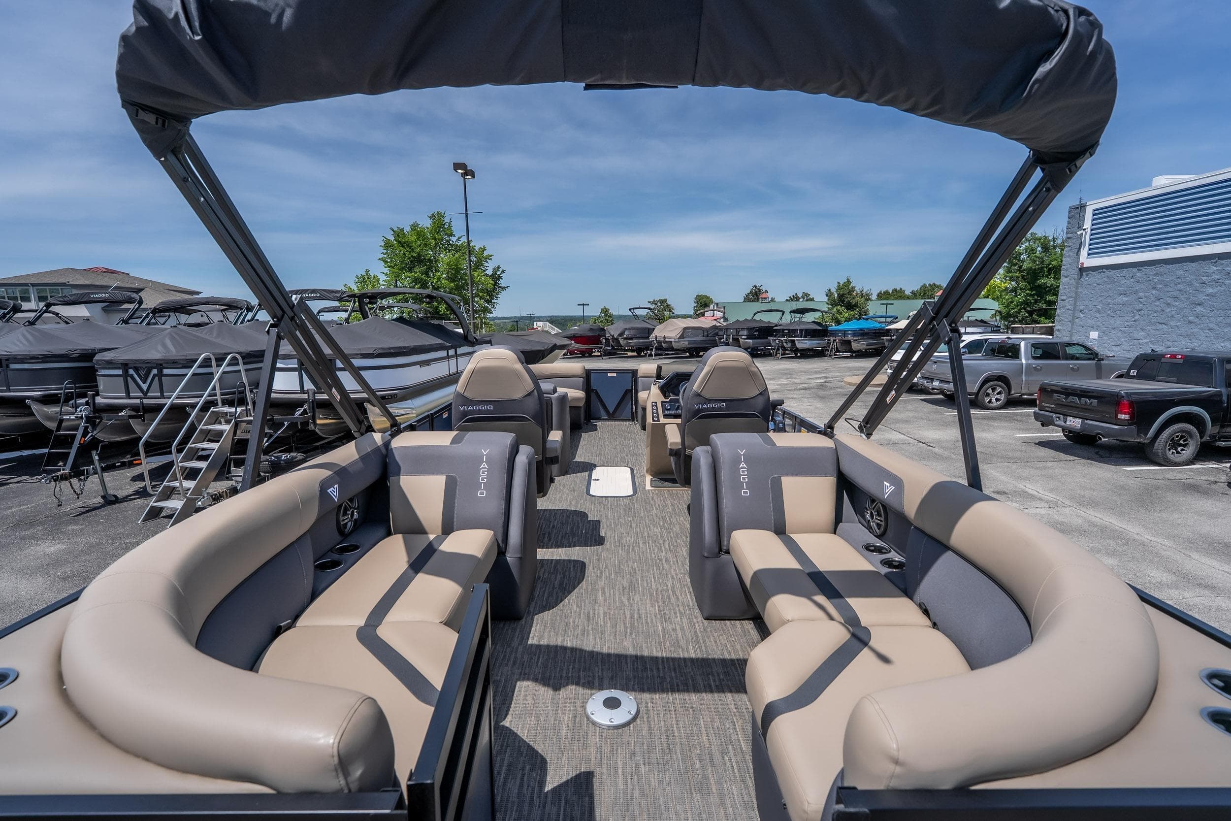 2026 Viaggio X24U pontoon boat with spacious seating and modern design at a dealership.