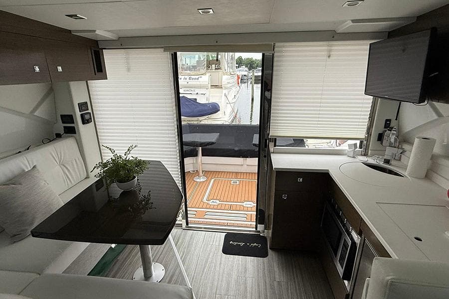 Interior of 2020 Cruisers Yachts 42 Cantius with modern kitchen and seating area.