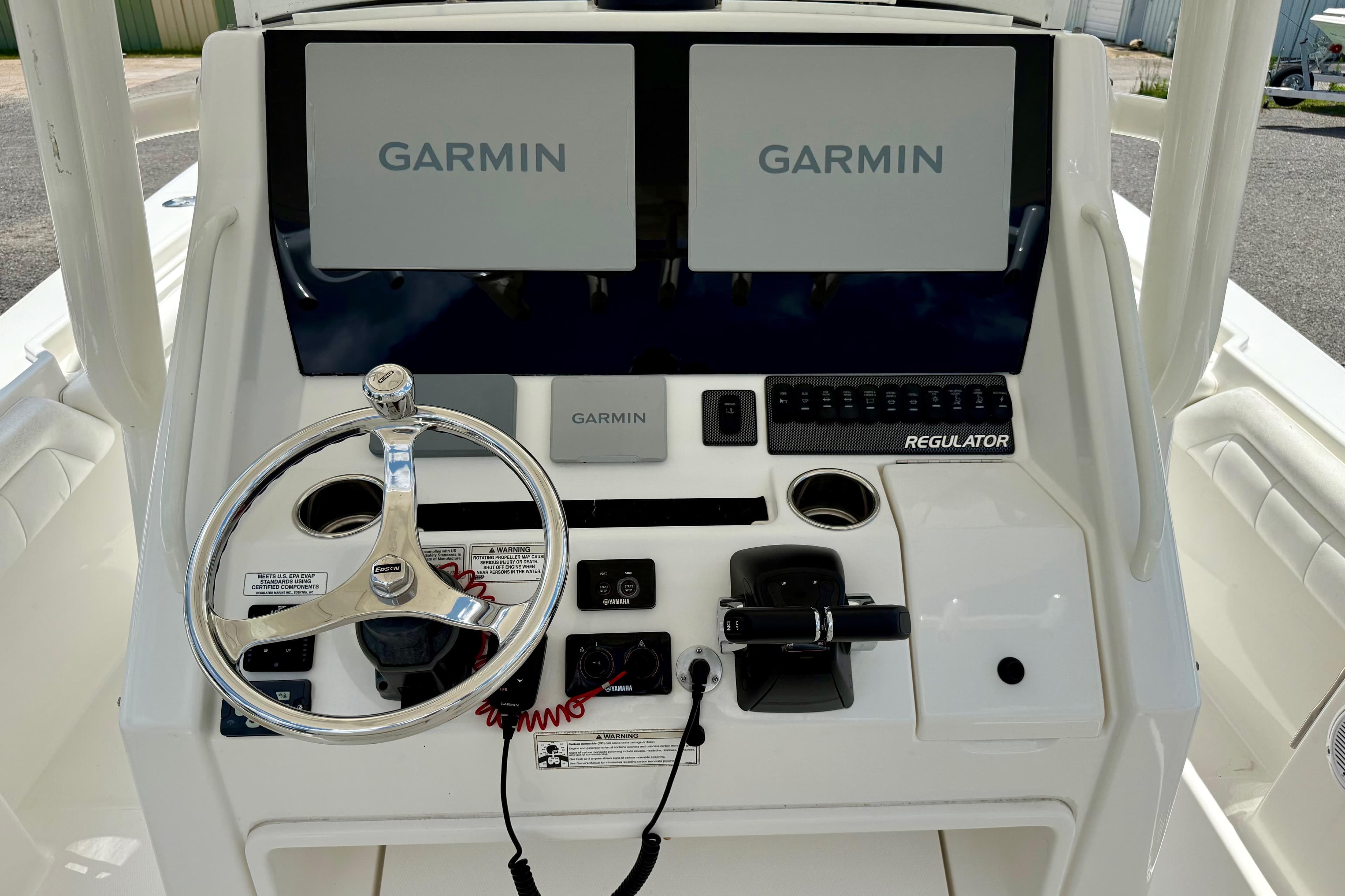 2017 Regulator 28 boat dashboard with dual Garmin displays and steering wheel.