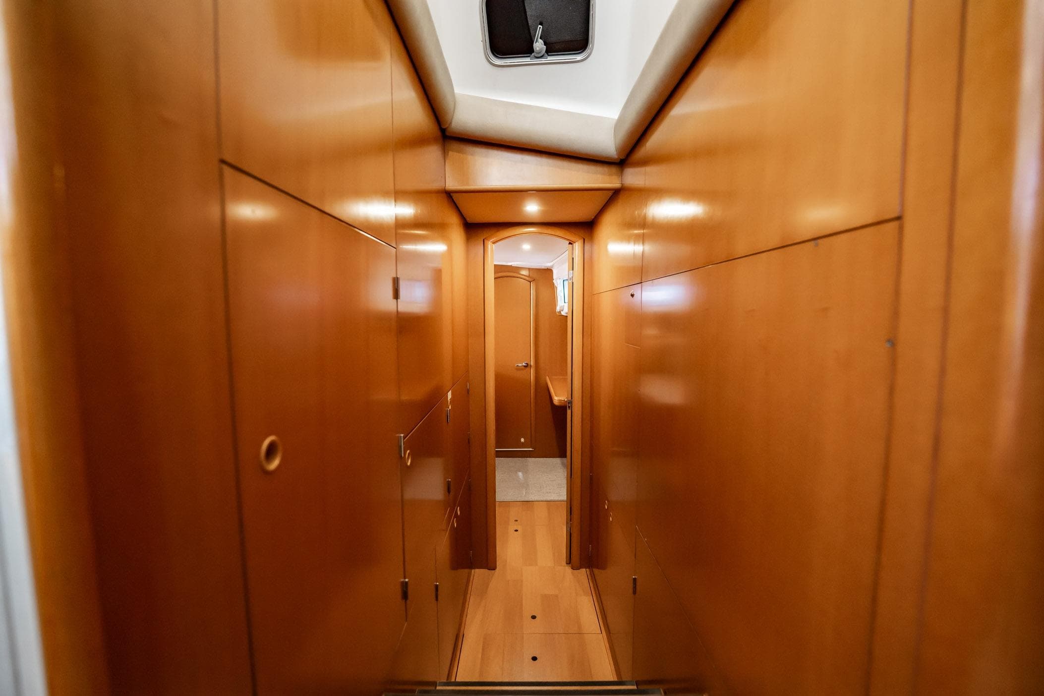 Interior hallway of 2005 Lagoon Power 43 yacht with wooden paneling.
