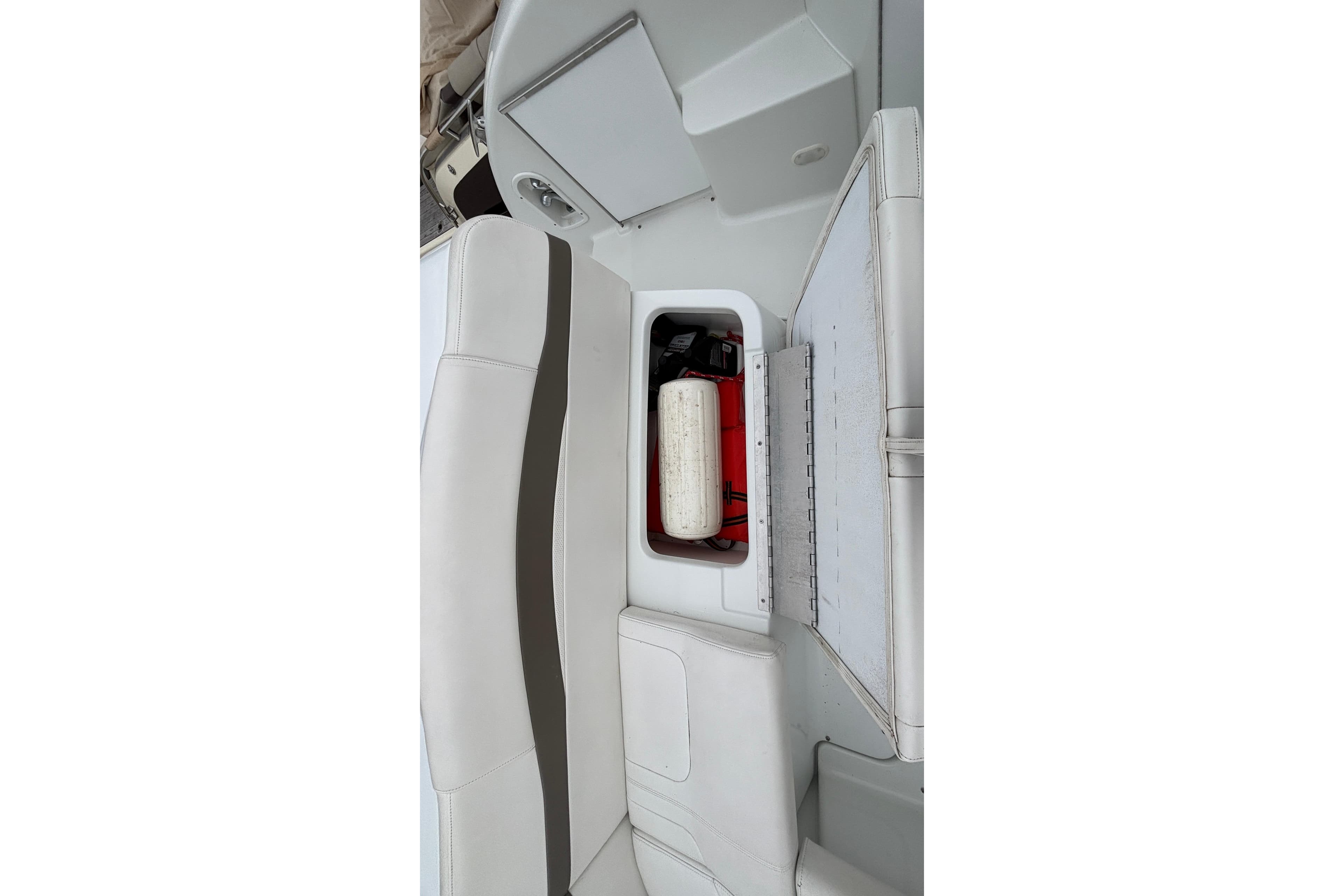 2005 Formula 31 Performance Cruiser interior storage compartment with white seating.