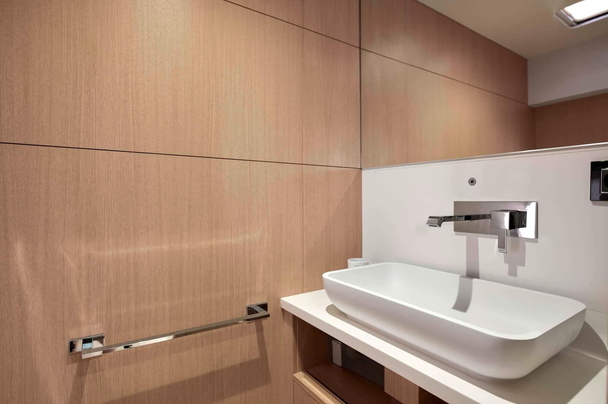 Modern bathroom with sleek sink and wooden paneling in Privilege Signature 580, 2025 model.