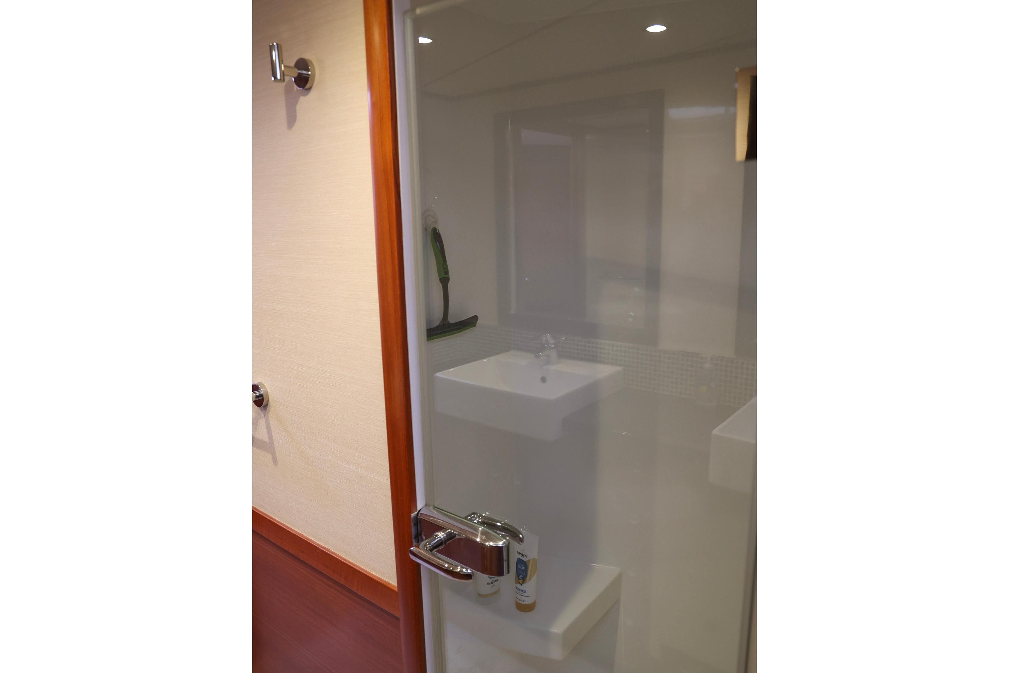 Bathroom interior of 2018 Nordhavn 76 yacht, featuring a modern sink and shower.