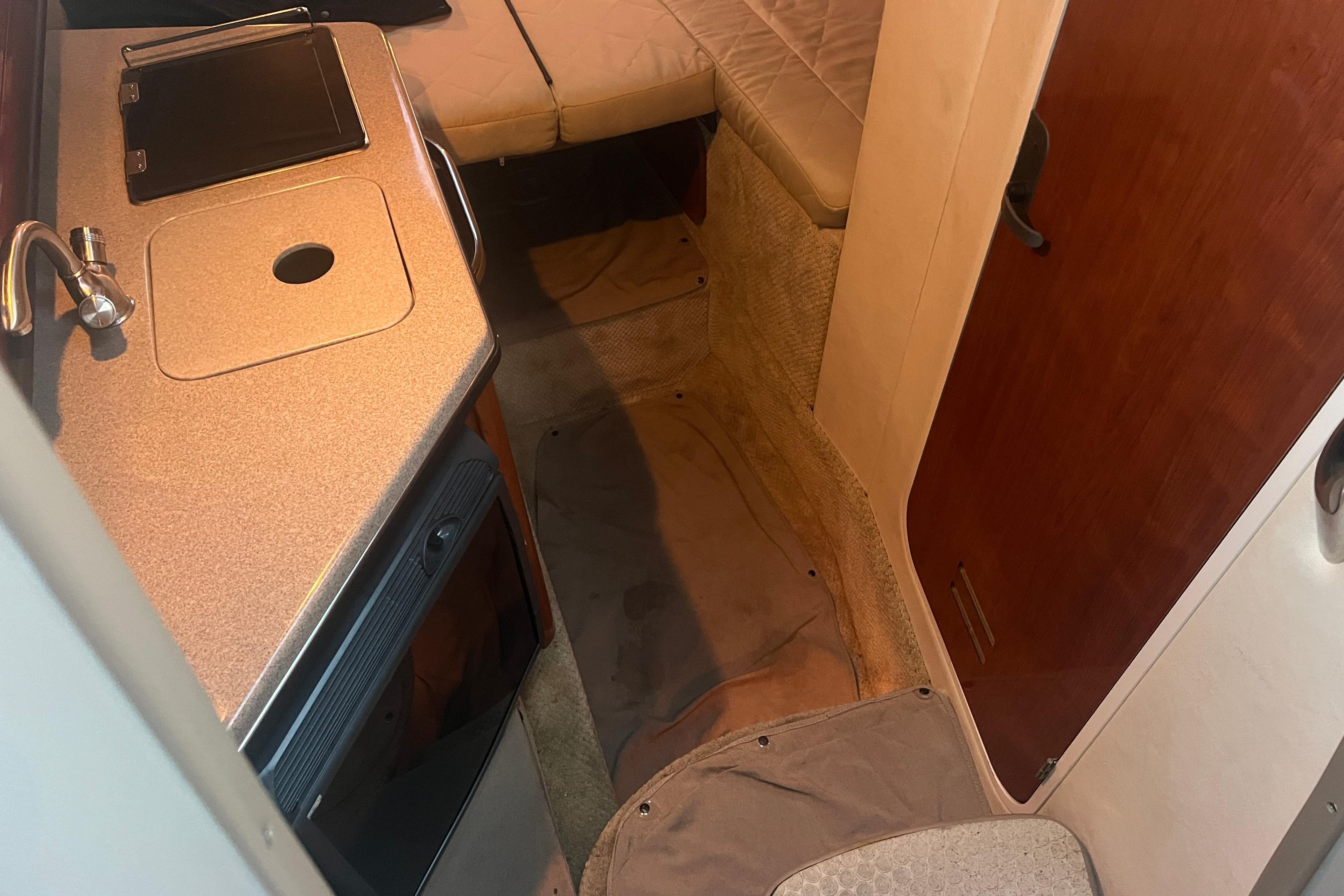 Interior of 2007 Sea Ray 260 Sundancer boat with kitchenette and seating area.
