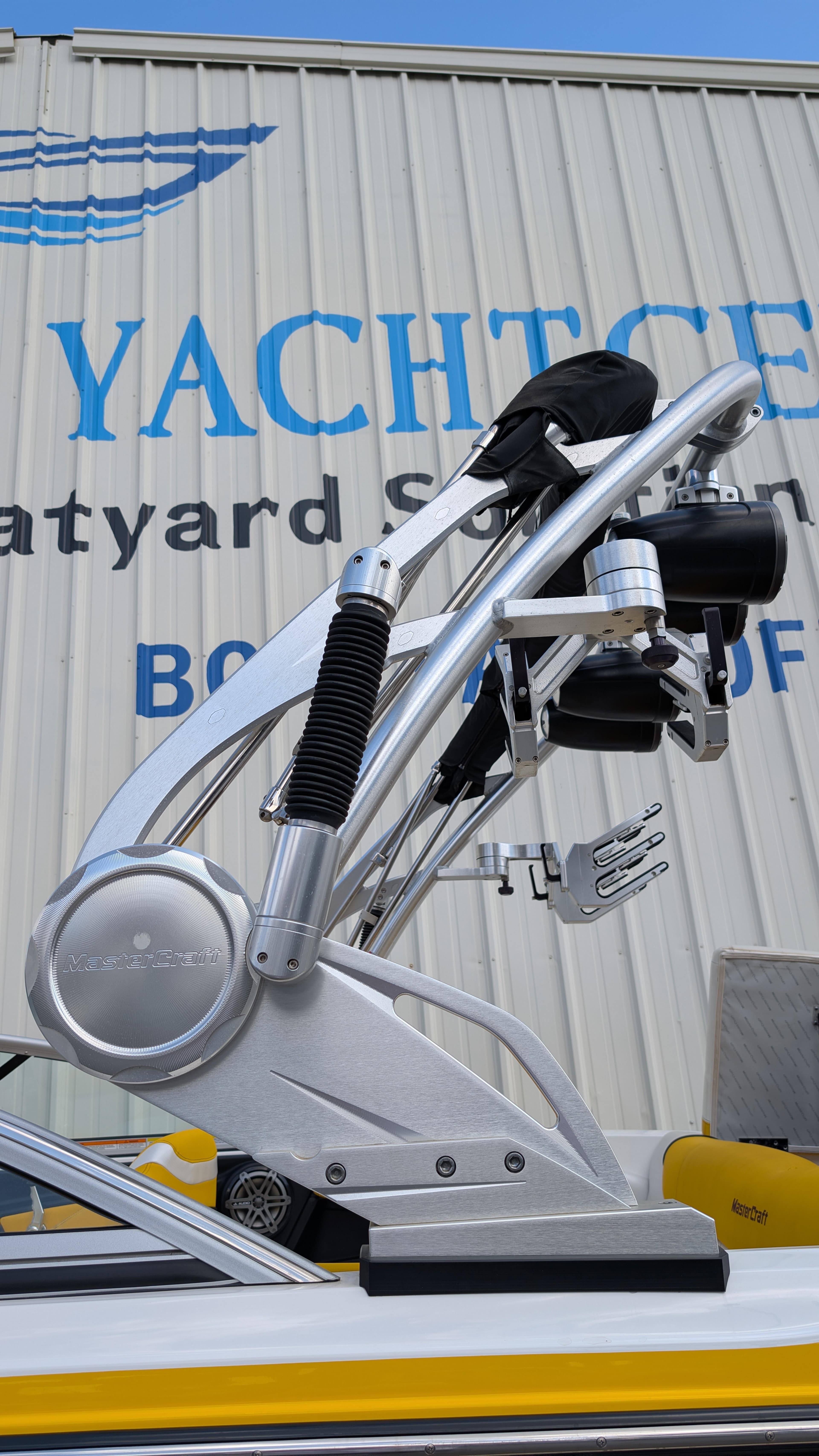 2013 MasterCraft X2 boat with wakeboard tower at a boatyard.
