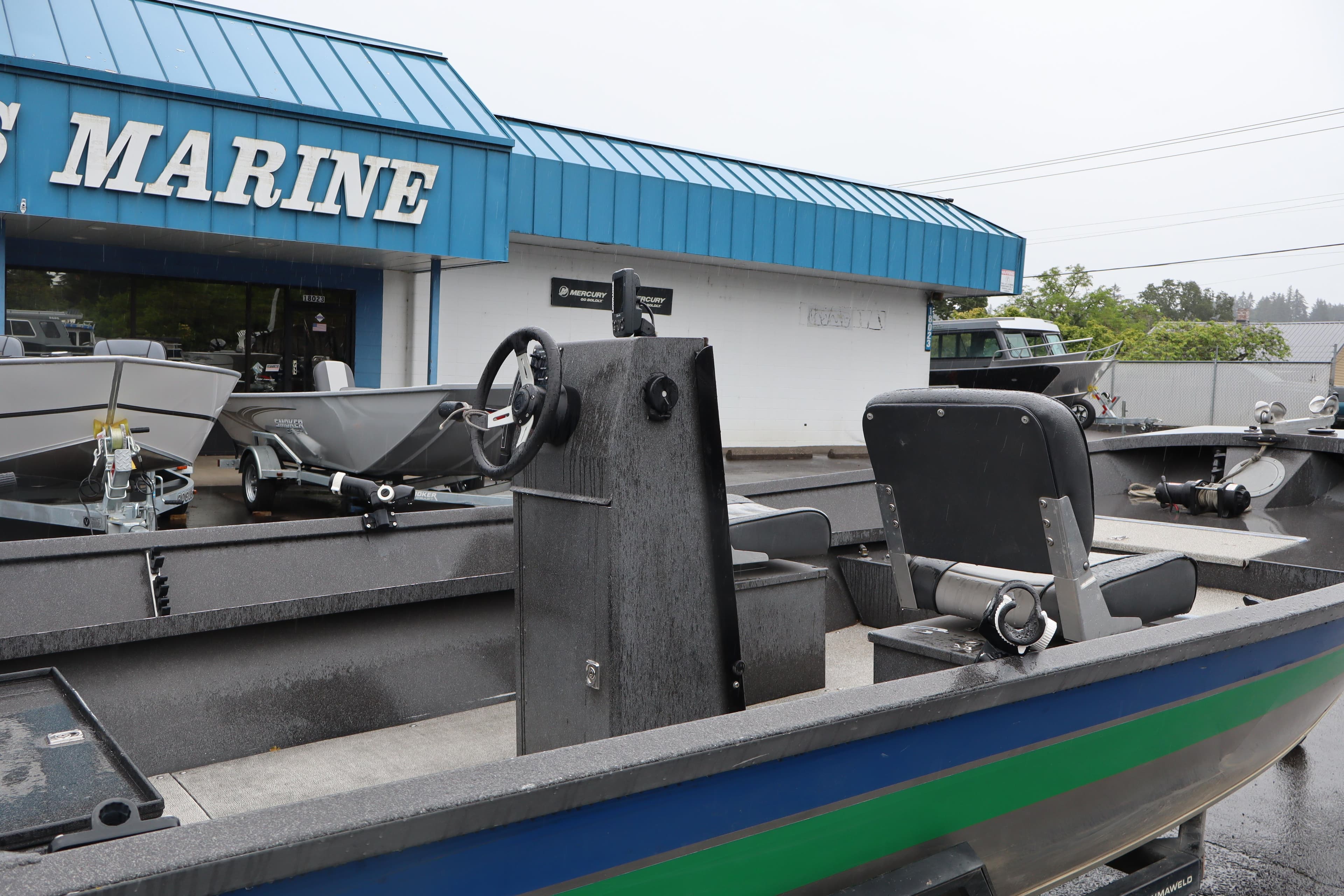 1994 Alumaweld 1544 Flatbottom boat displayed outside a marine dealership.