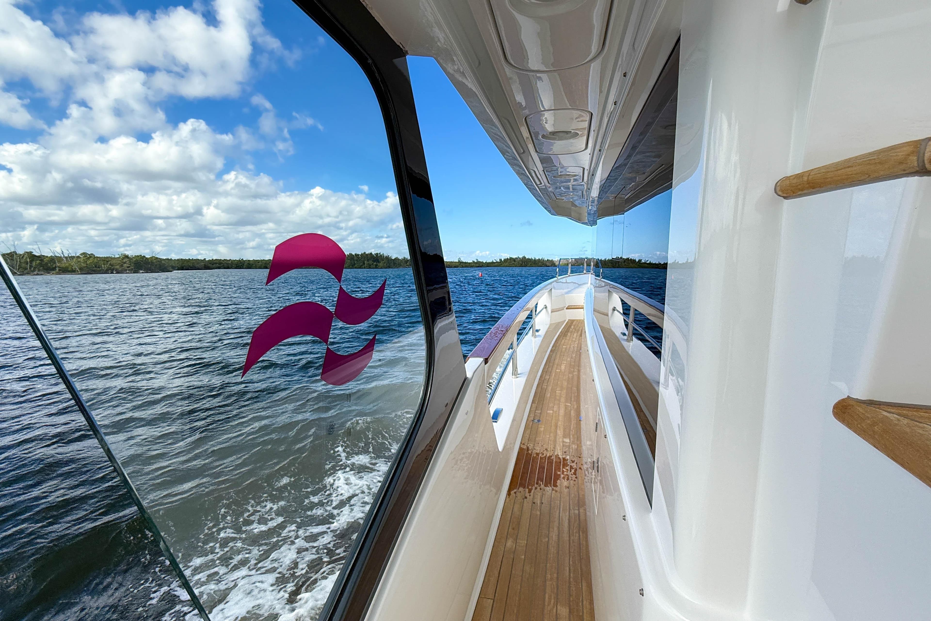 2023 Sirena 68 yacht deck with ocean view and clear skies.