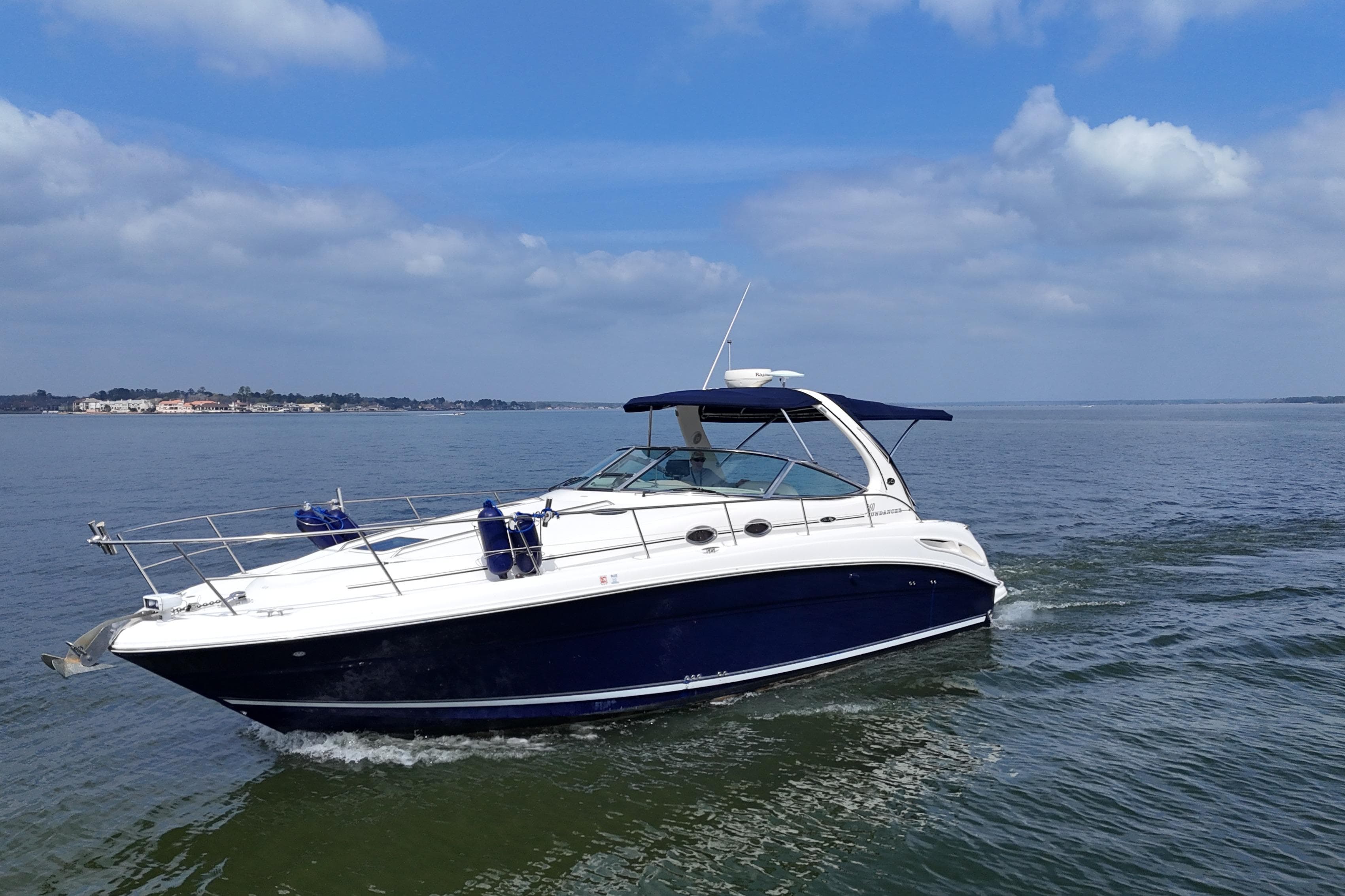 2005 Sea Ray 360 Sundancer cruising on calm waters under a blue sky.