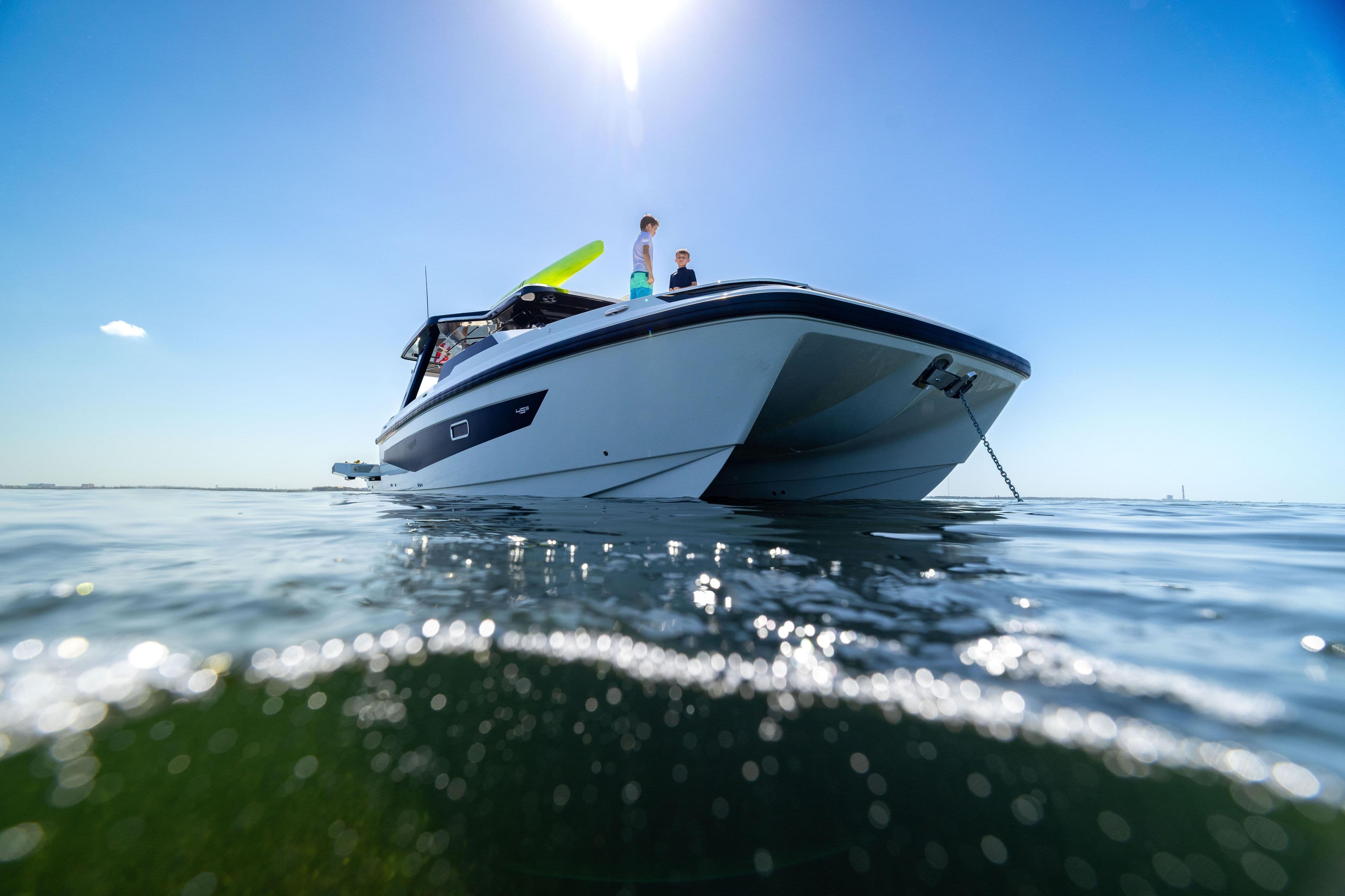 Aquila 45 Sport 2026 yacht on calm water under clear blue sky.