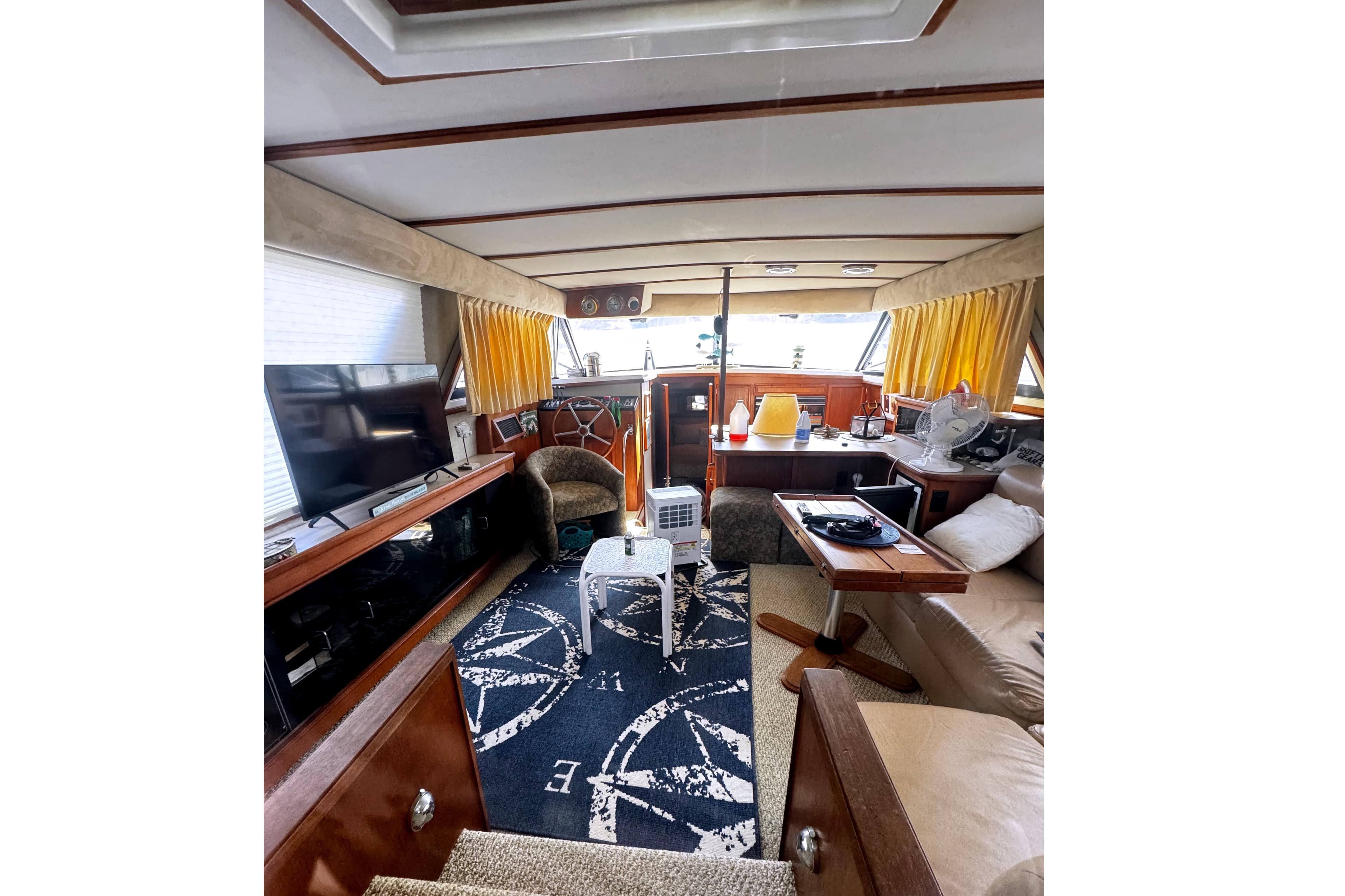 Interior of 1986 Carver 42 Aft Cabin Motor Yacht with cozy seating and nautical decor.