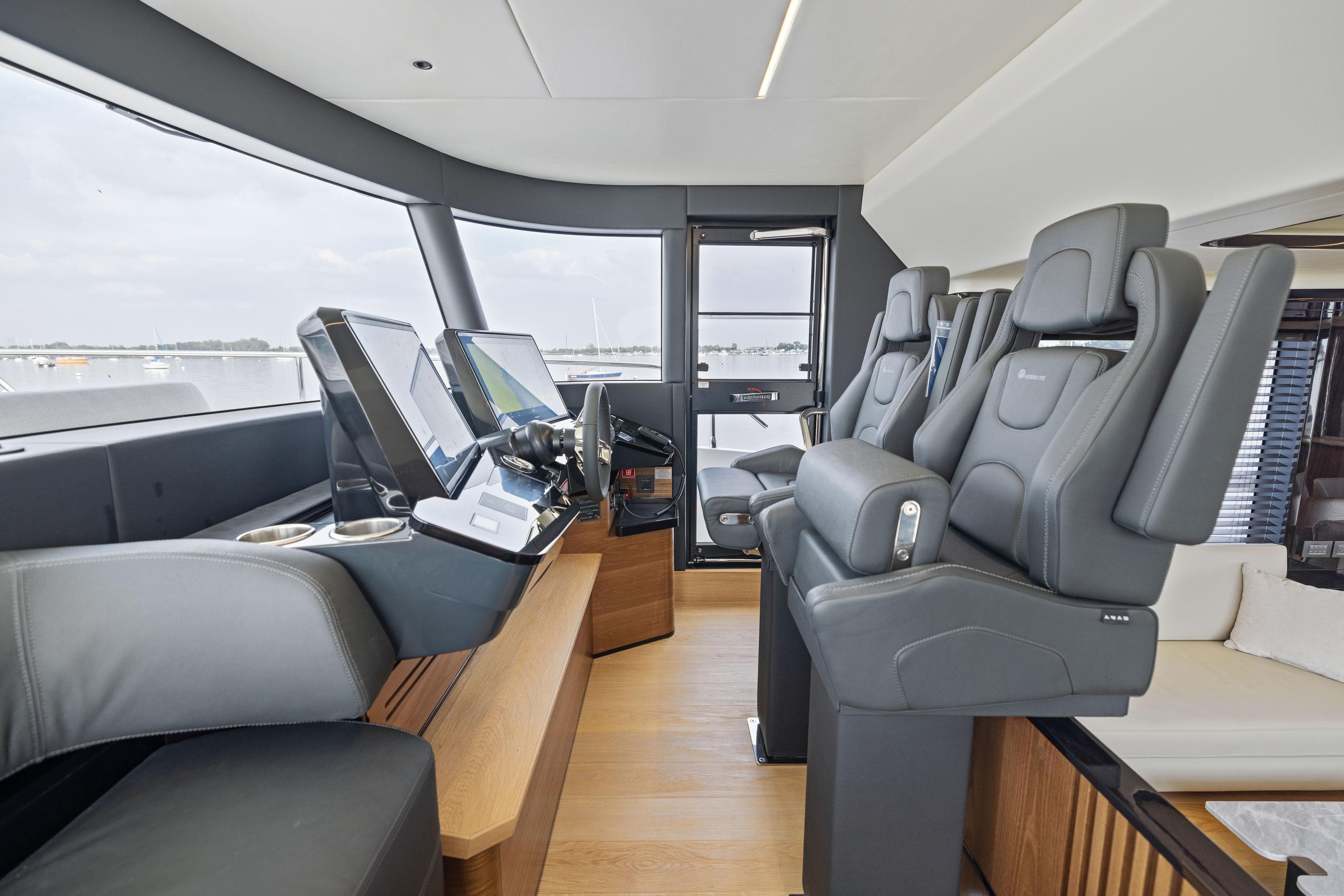 2024 Absolute Navetta 64 yacht helm with modern controls and luxurious seating.