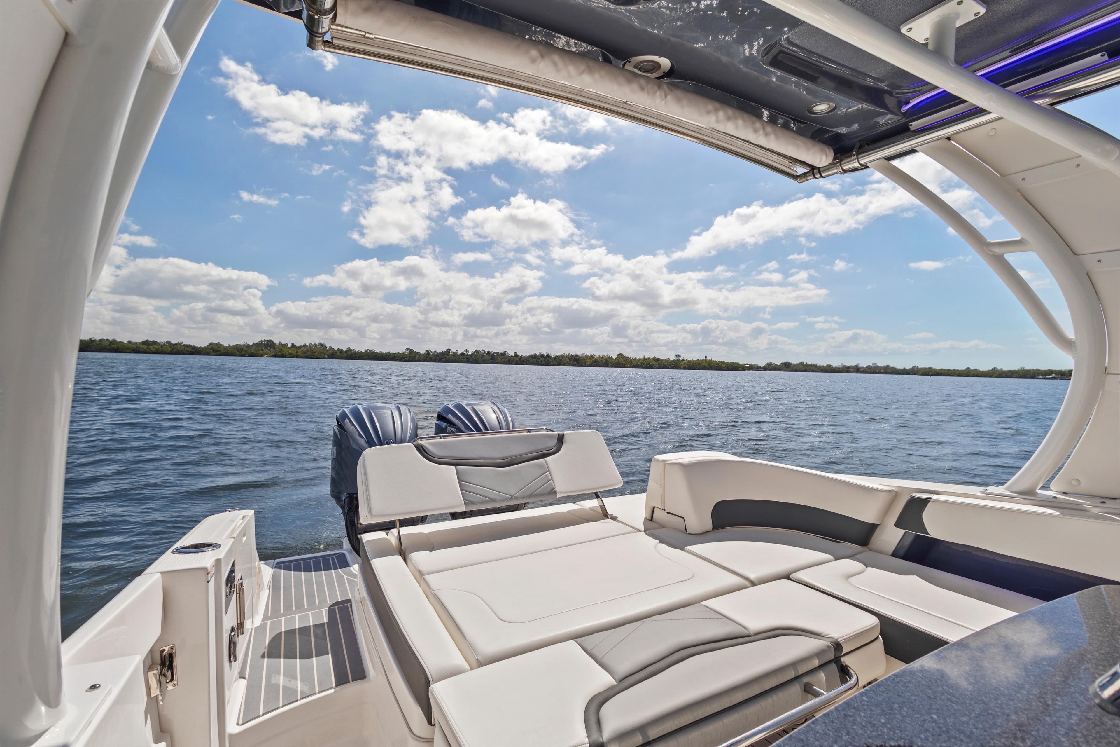 2022 Chaparral 300 OSX boat interior with scenic water view and clear sky.