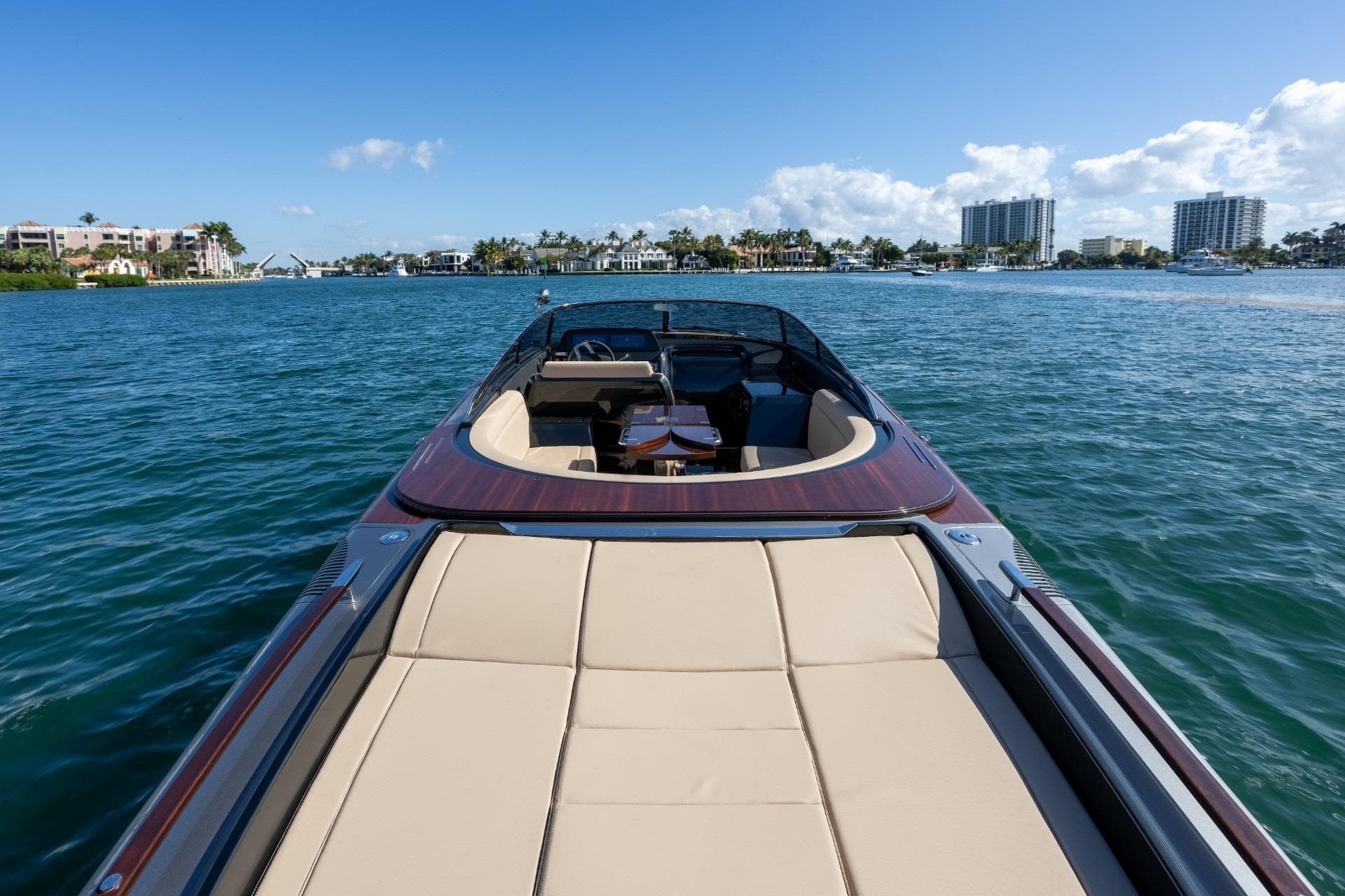 2025 Riva 33' Aquariva Special luxury boat on serene water with cityscape background.