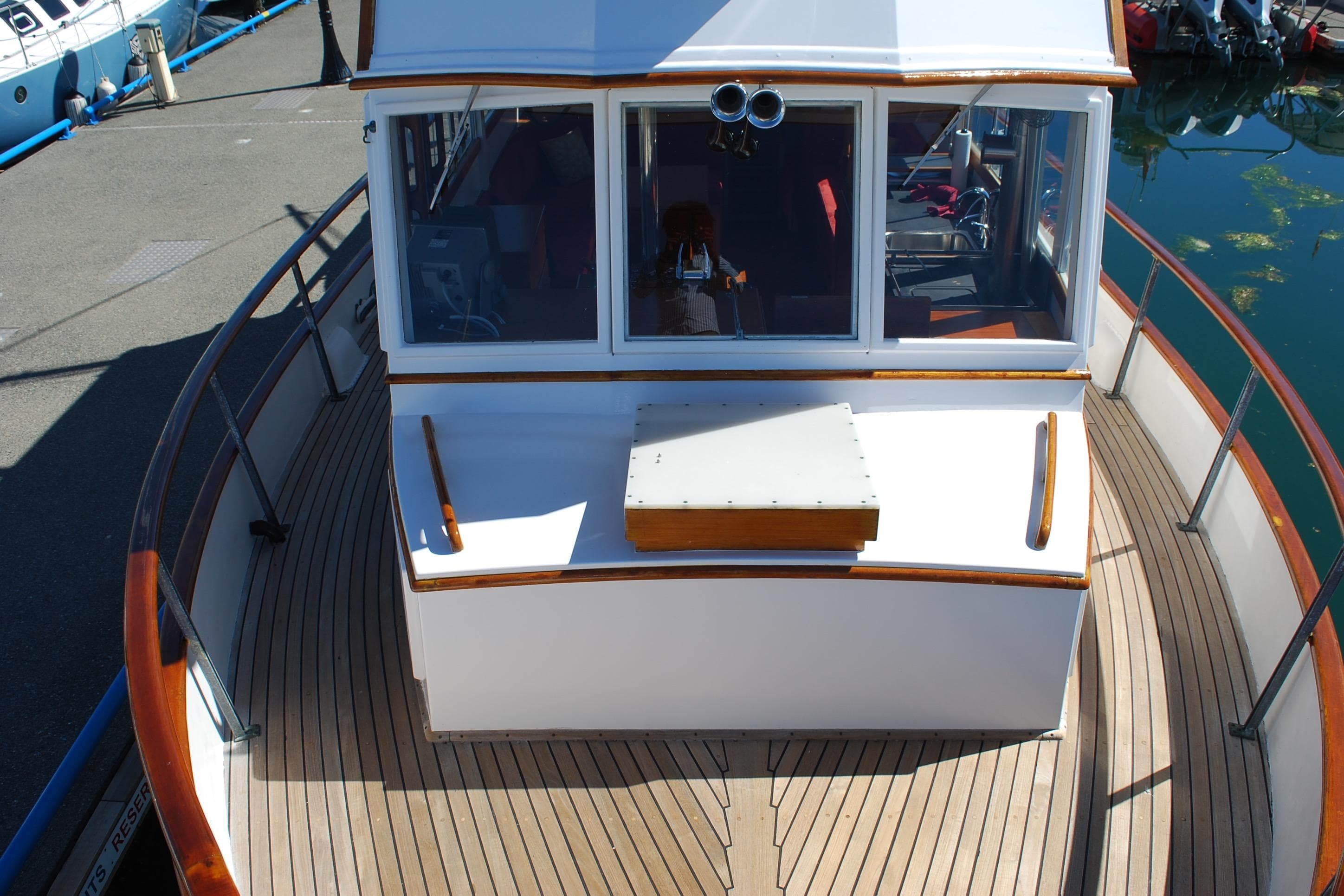 1971 Grand Banks 36 Classic yacht with wooden deck and cabin, docked at marina.
