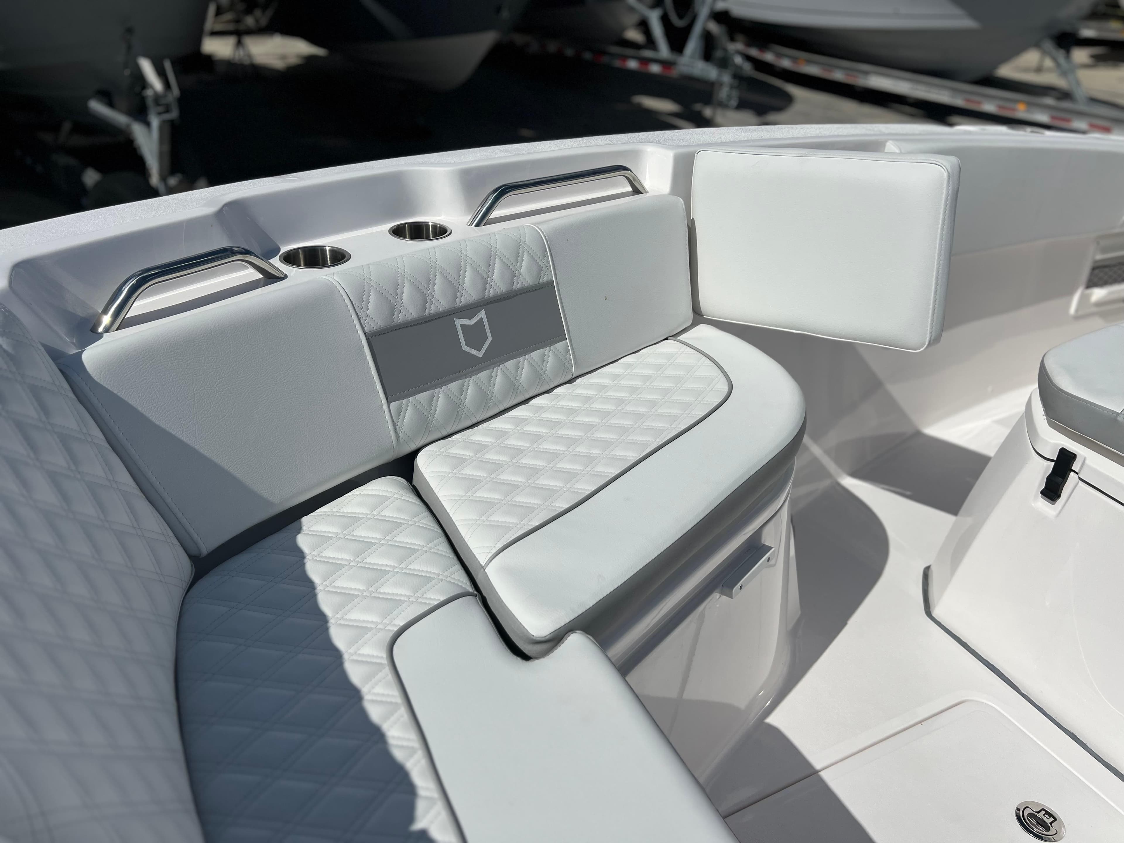 2025 Sea Fox 268 Commander boat interior with cushioned seating and cup holders.
