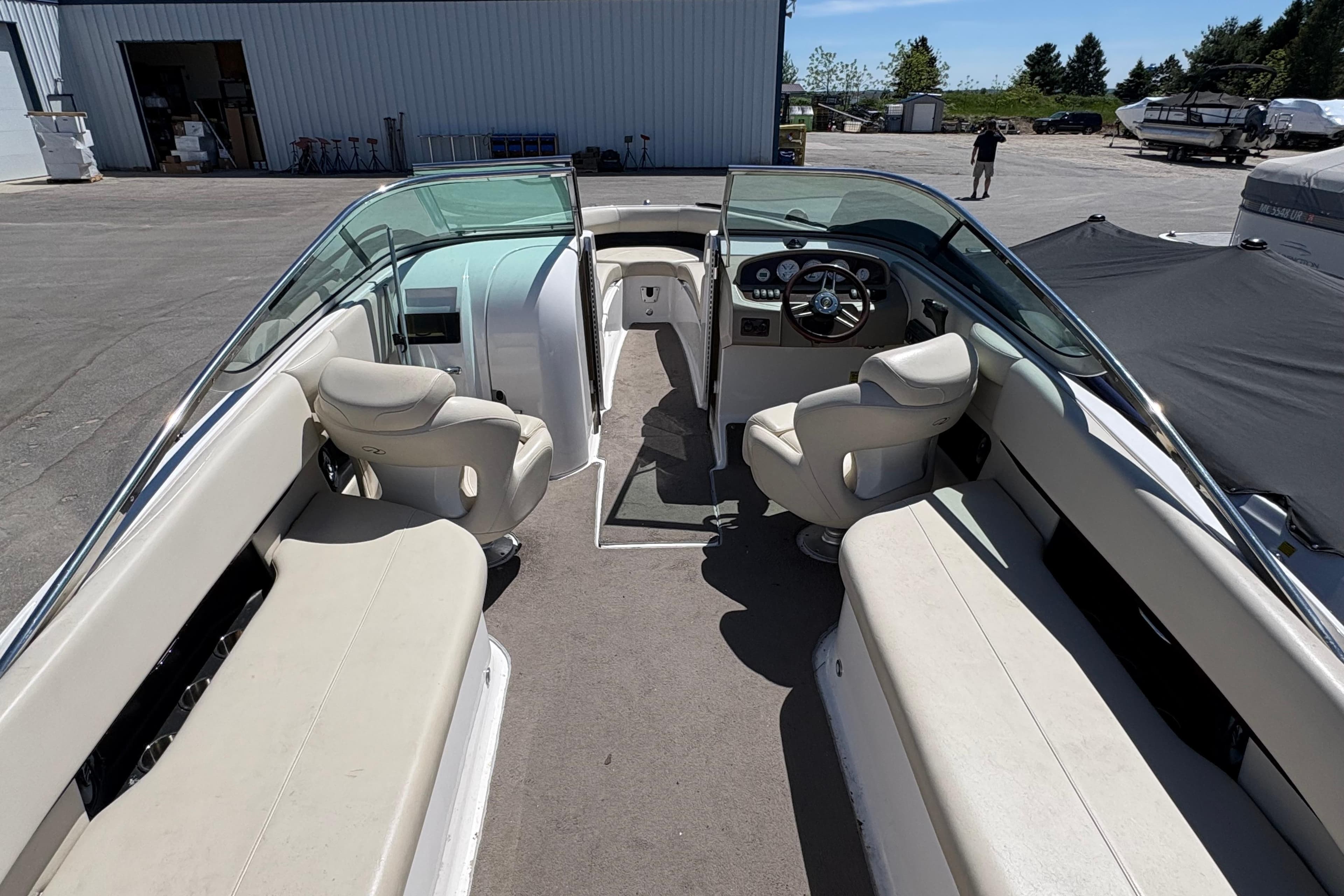 2009 Regal 2500 Bowrider boat interior with seating and steering wheel, parked outdoors.