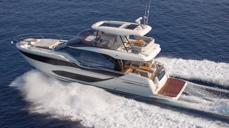 Luxurious 2026 Prestige F5.7 yacht cruising swiftly on open blue waters.