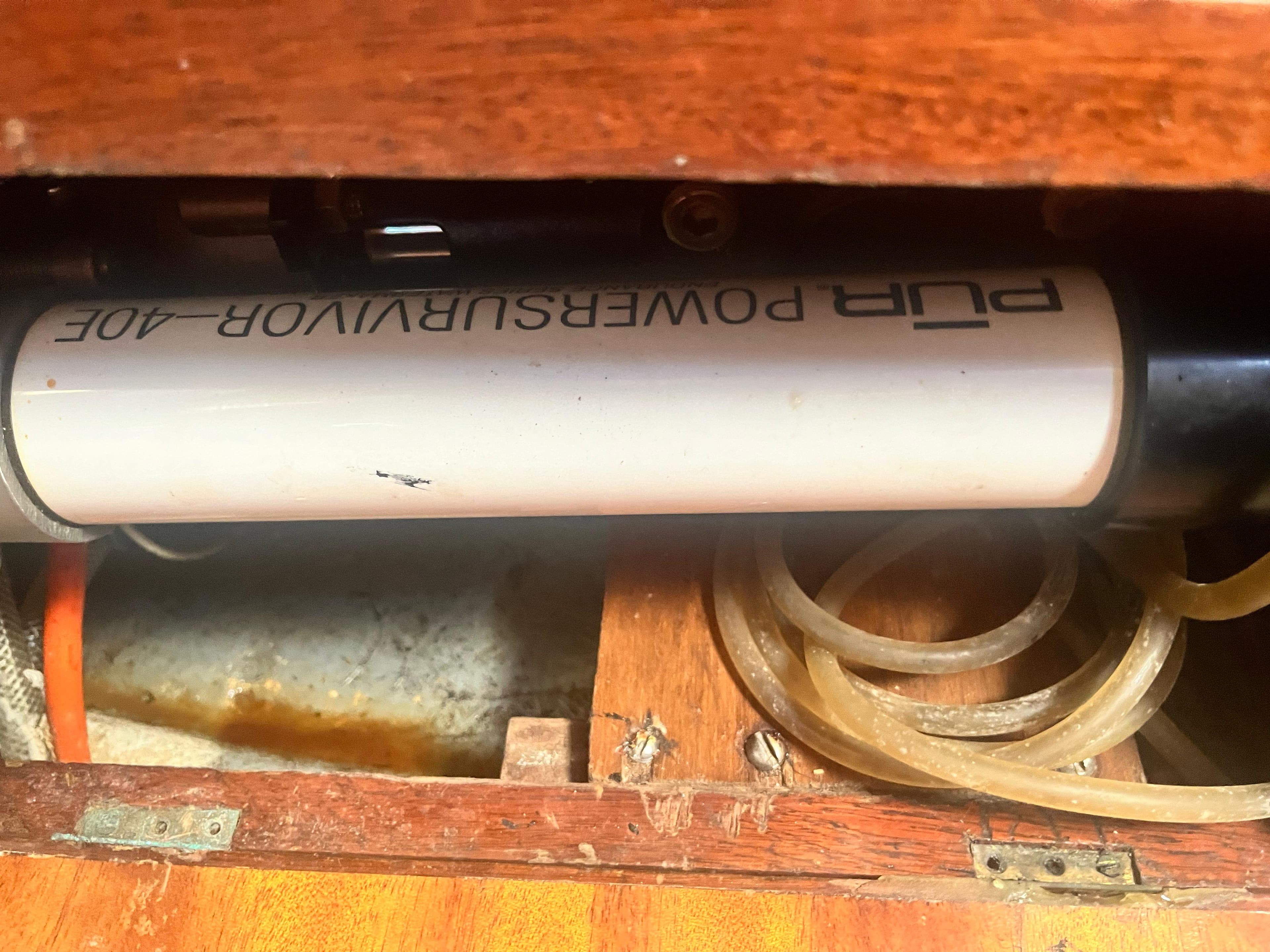 PowerSurvivor A06 pump inside Trident Marine Challenger 35, 1981 model, with wooden and metal components.