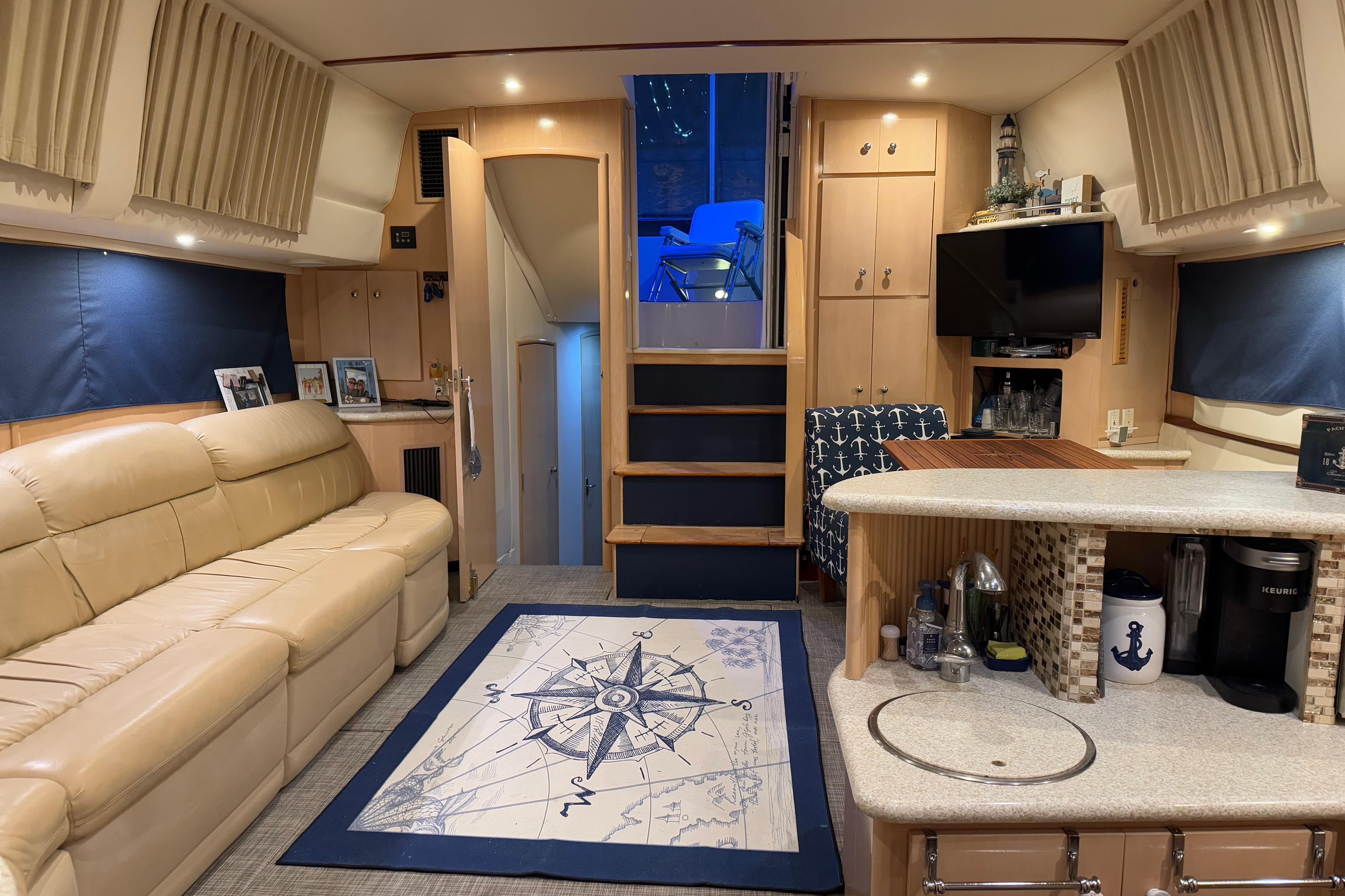 Luxurious interior of 2000 Carver 396 Motor Yacht with cozy seating and nautical decor.