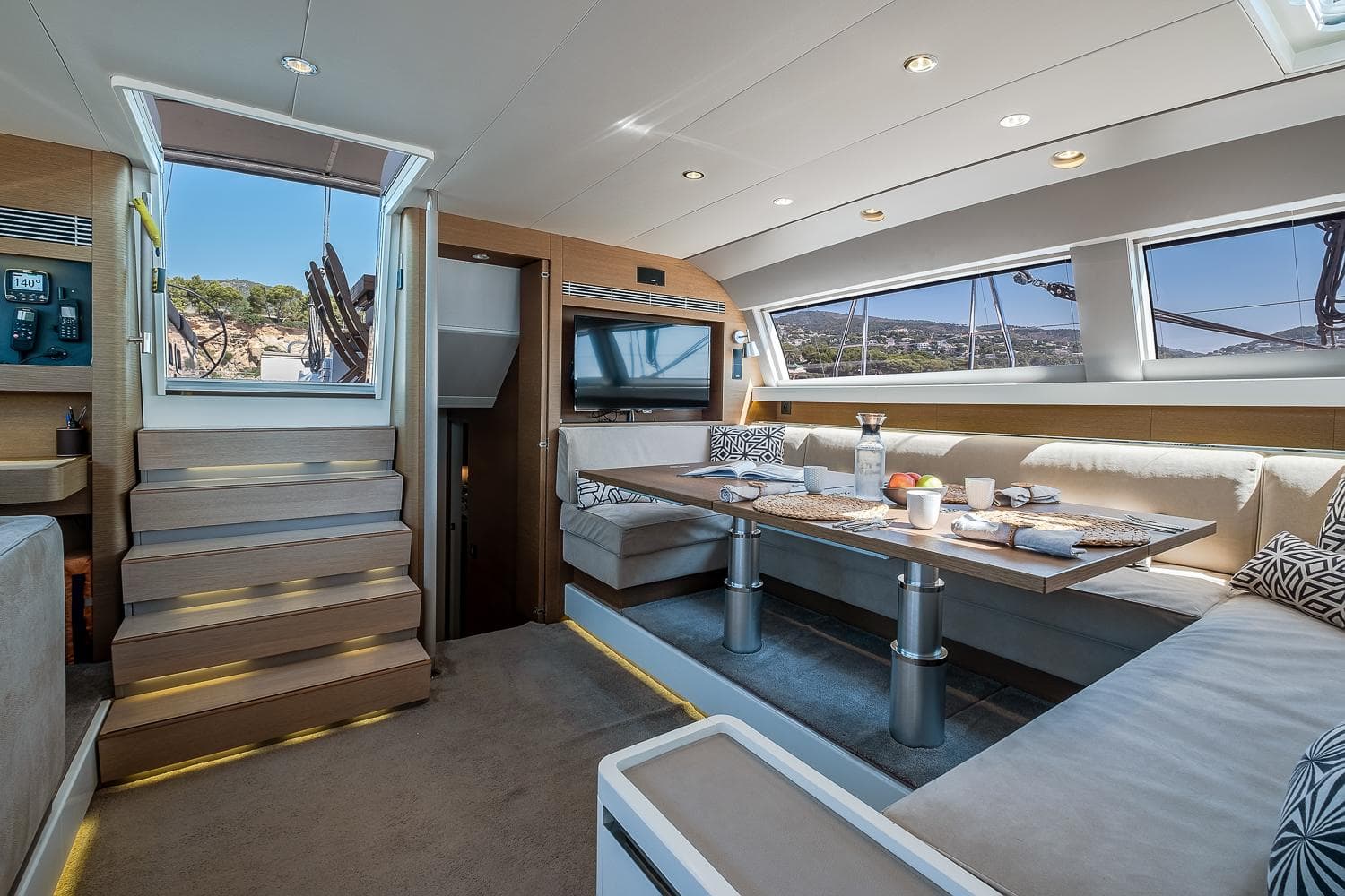 Luxurious interior of 2017 CNB 76 yacht with elegant dining area and scenic views.