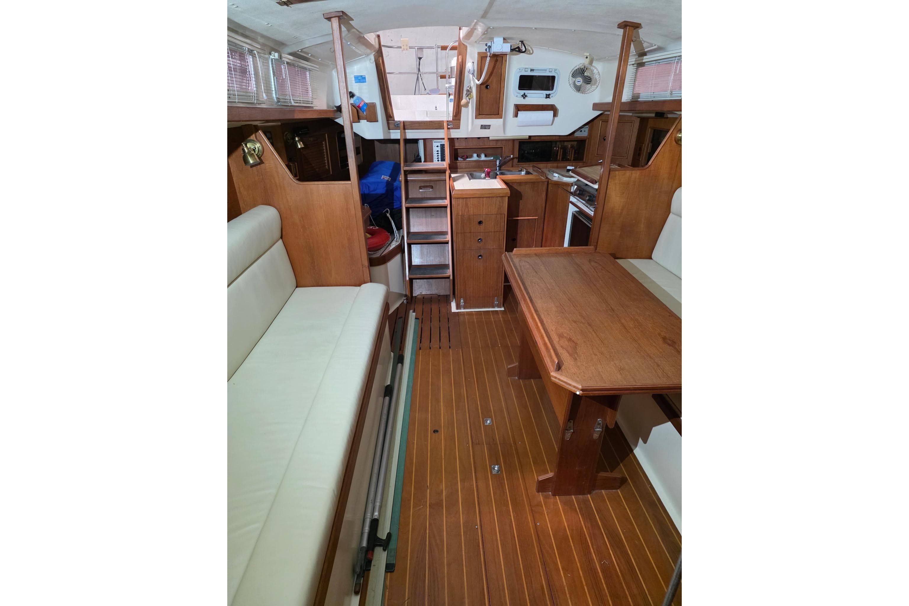 Interior of 1985 Hinterhoeller Niagara 35 Encore sailboat with wooden furnishings and seating.