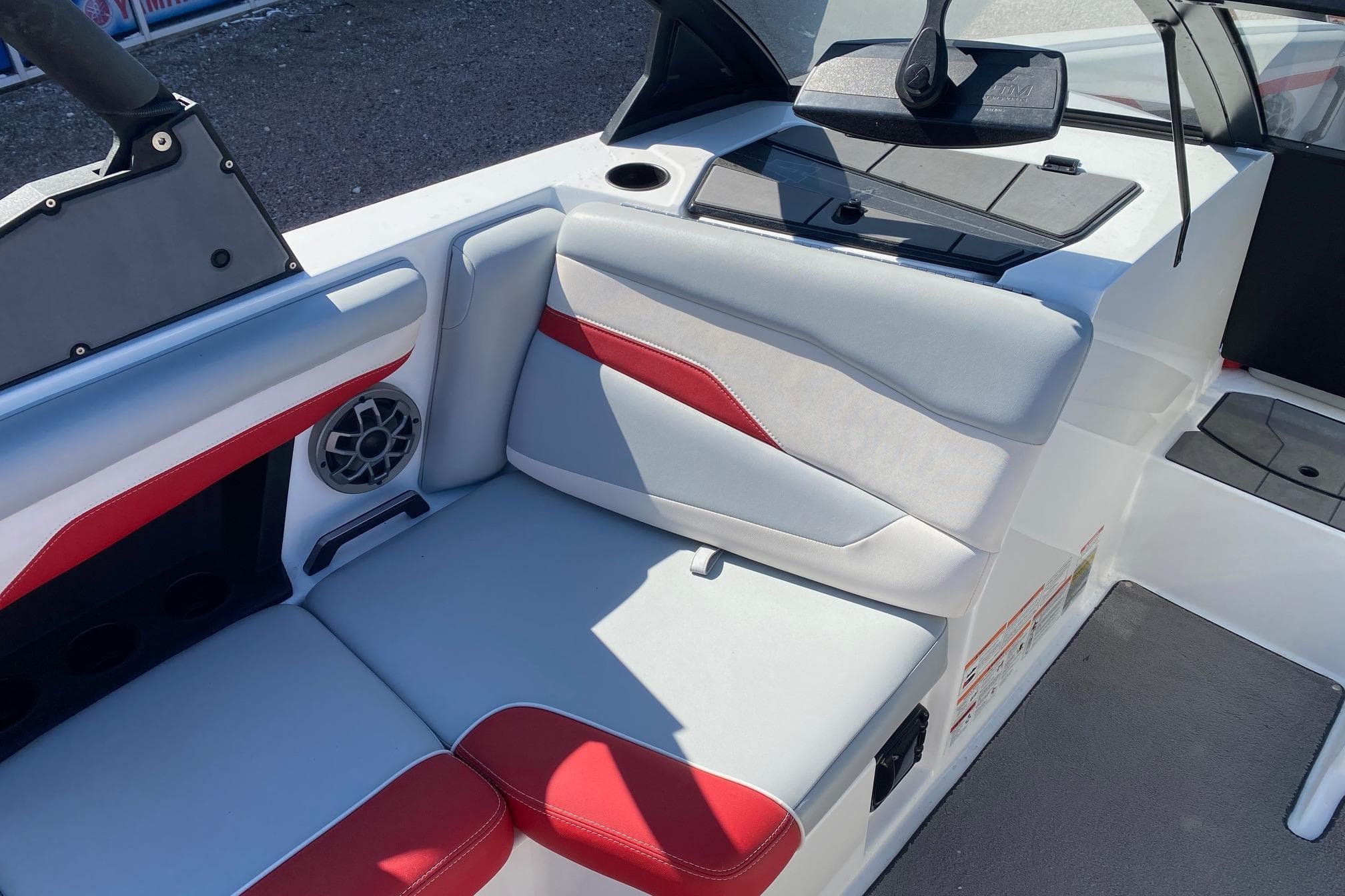 2023 Axis T220 boat interior with red and white seating, speaker, and storage compartment.