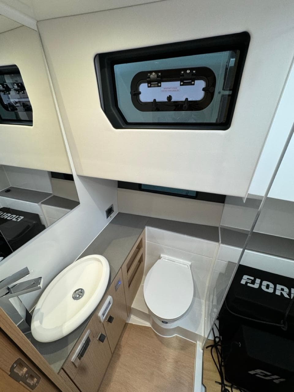 2024 Fjord 41 XL yacht bathroom with modern fixtures and window.