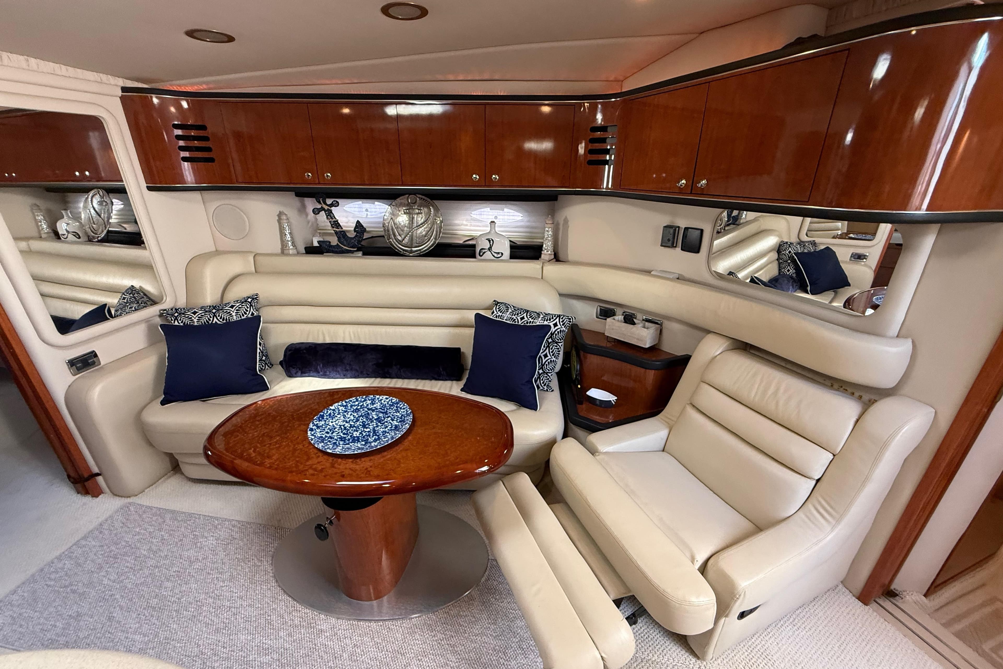 Luxurious interior of 2003 Sea Ray 460 Sundancer yacht with elegant seating and wooden cabinetry.