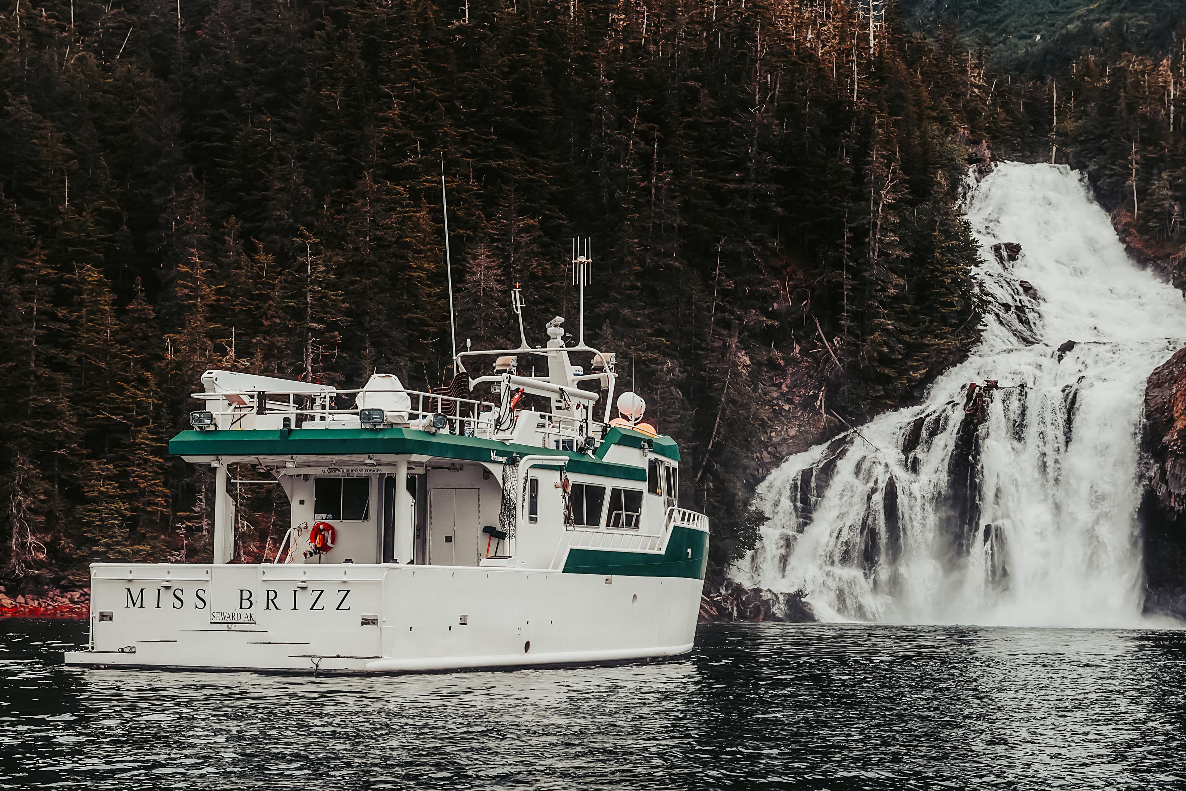 Peregrine 62 Custom yacht near waterfall, forested backdrop, 2003 model.