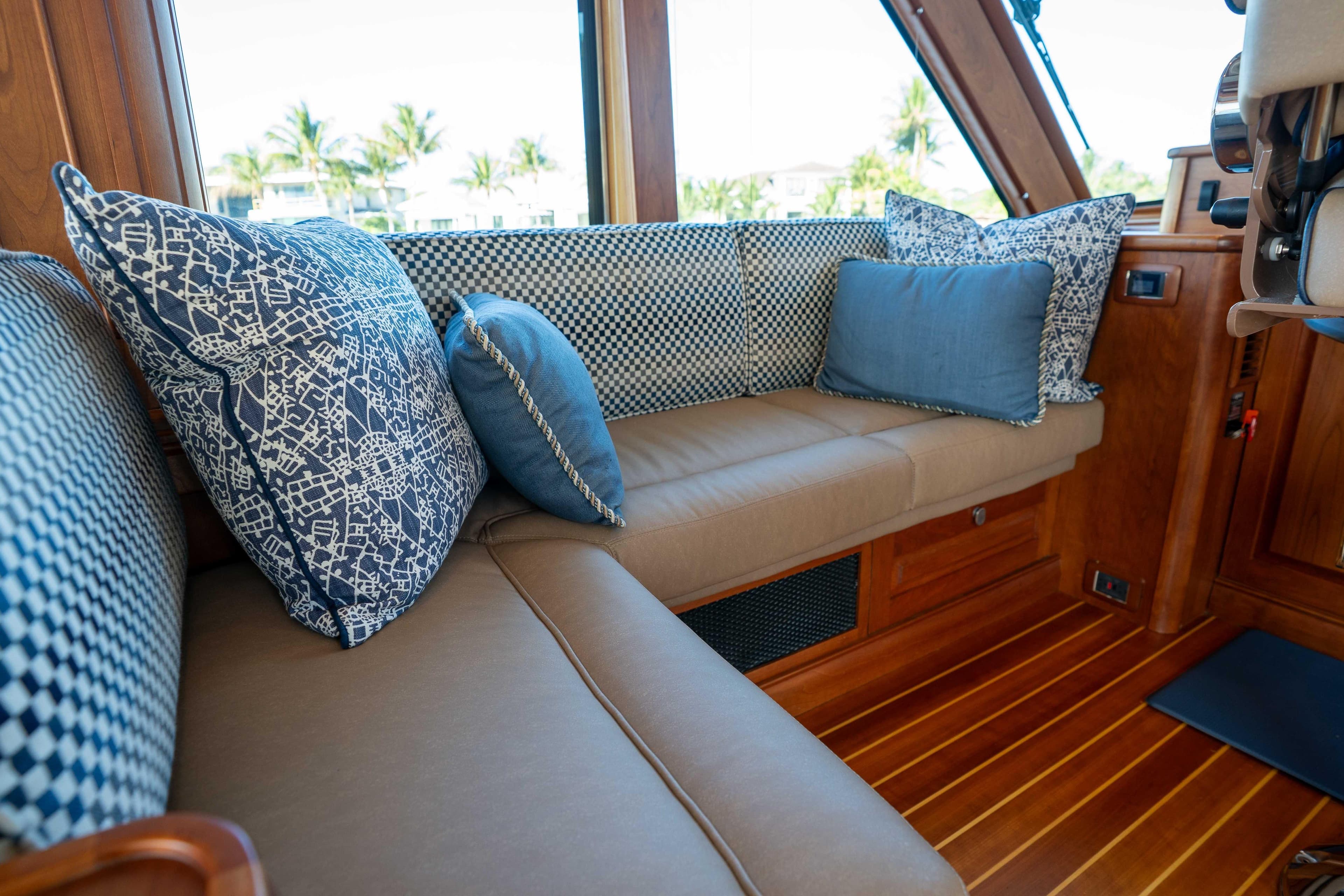 Luxurious interior of 2018 Sabre 66 Dirigo yacht with elegant cushions and wooden finish.