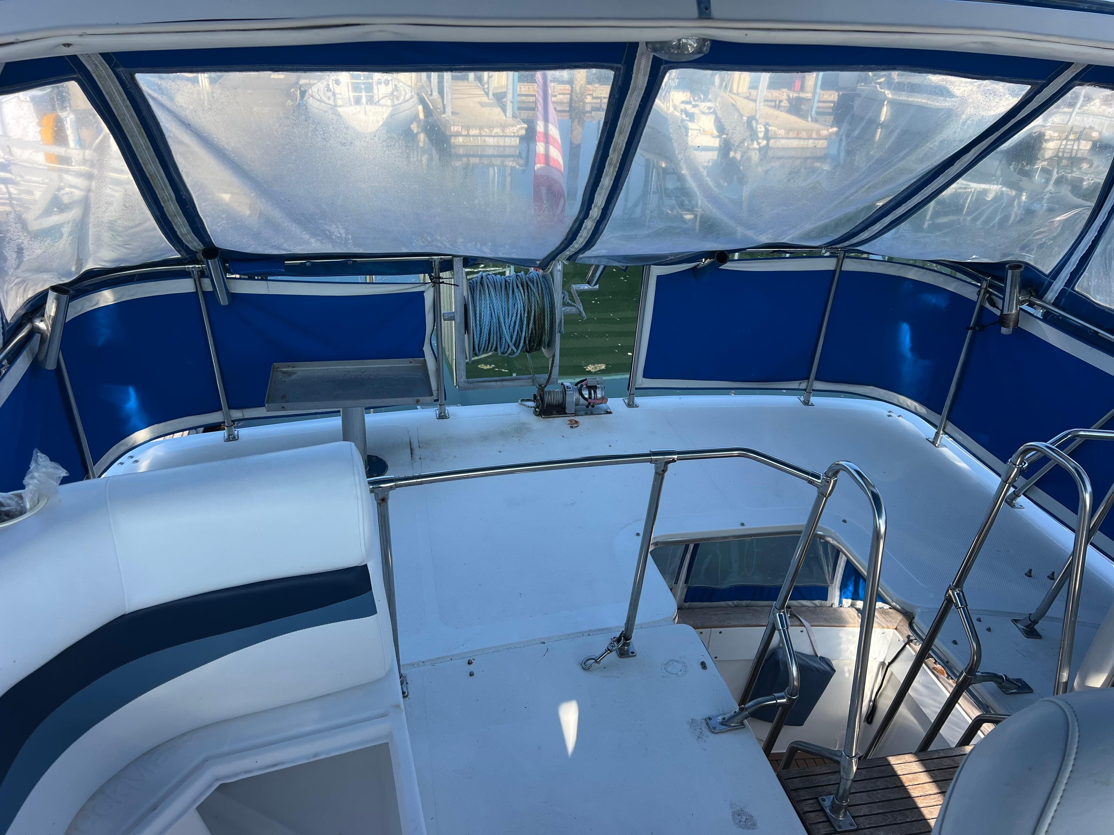 1986 Bayliner 3870 Motoryacht cockpit with blue canopy and seating area.