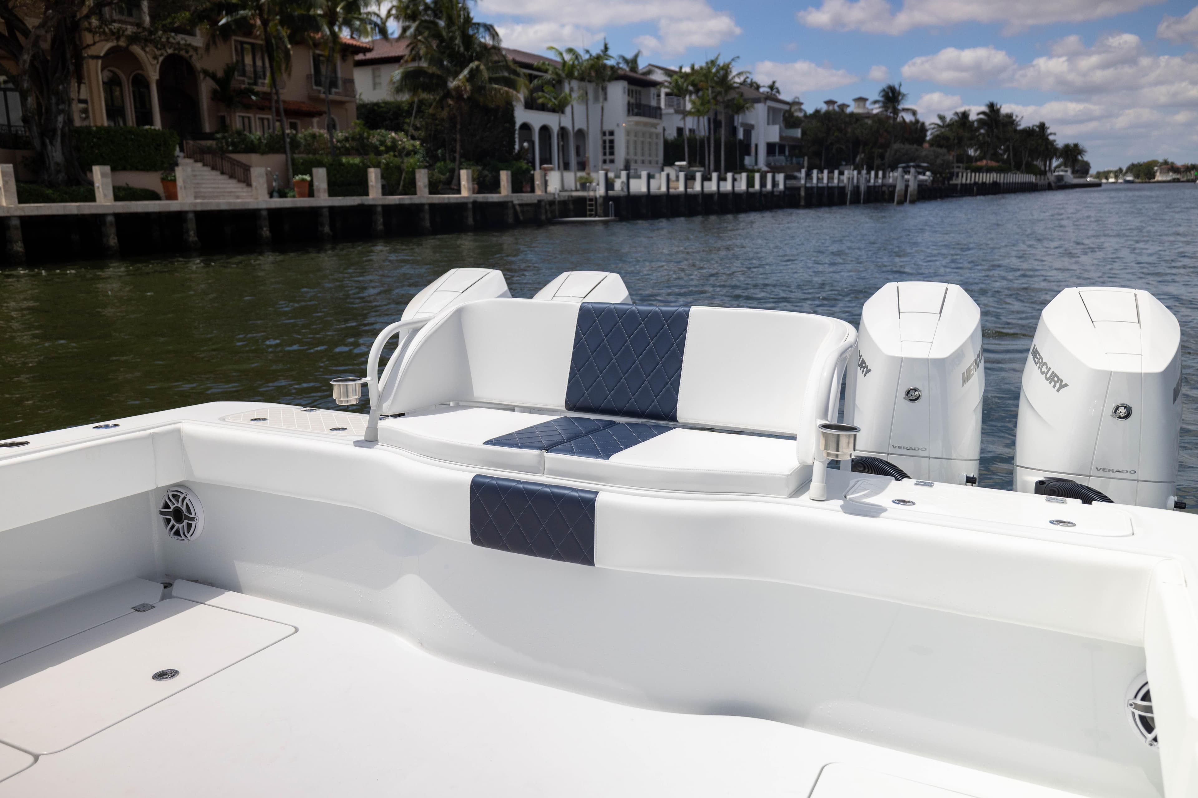 2026 Freeman 47 LX boat with luxurious seating and powerful Mercury engines on a scenic waterway.