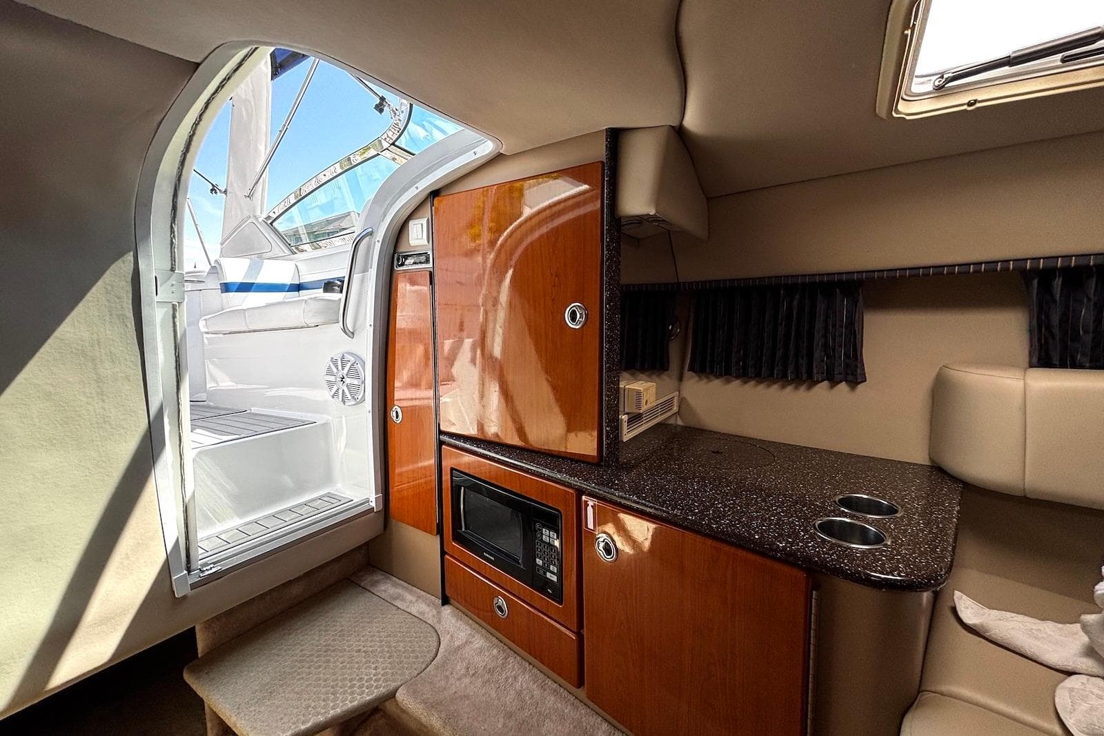 Interior of a 2004 Formula 330 Sun Sport boat with kitchenette and seating area.
