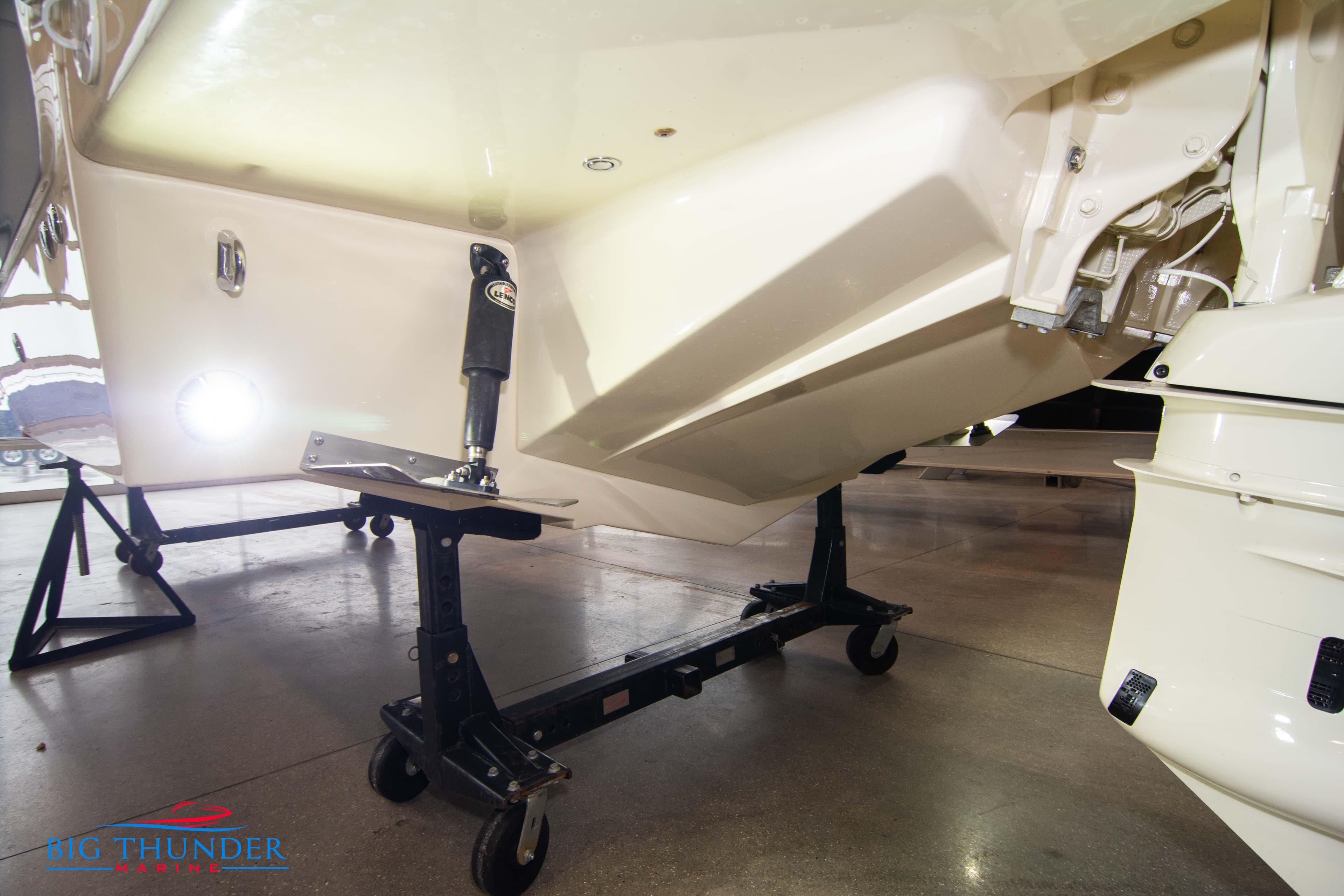 2024 Invictus TT280S boat hull on a stand in a showroom.