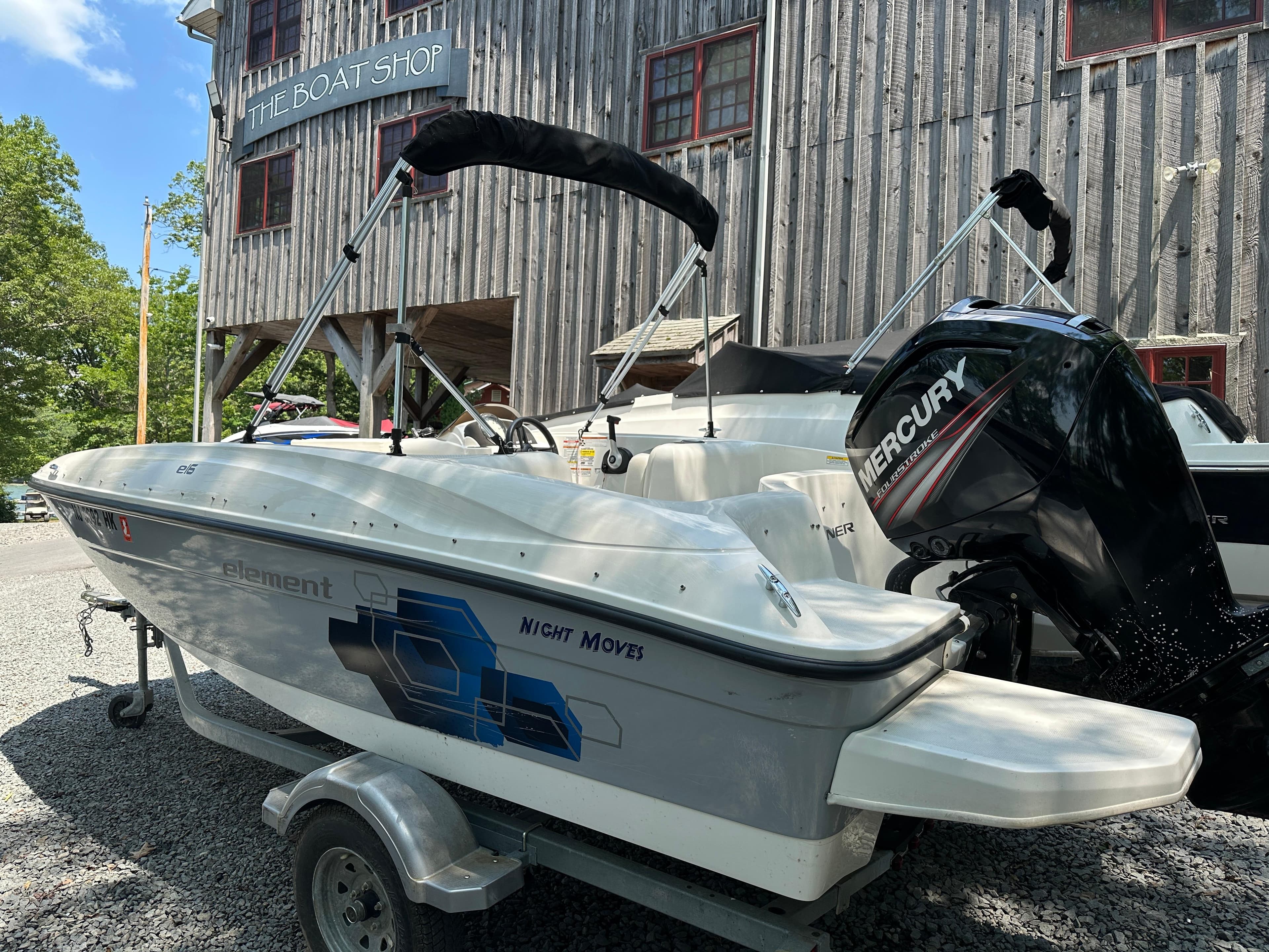 2019 Bayliner Element E16 boat with Mercury engine at a boat shop.