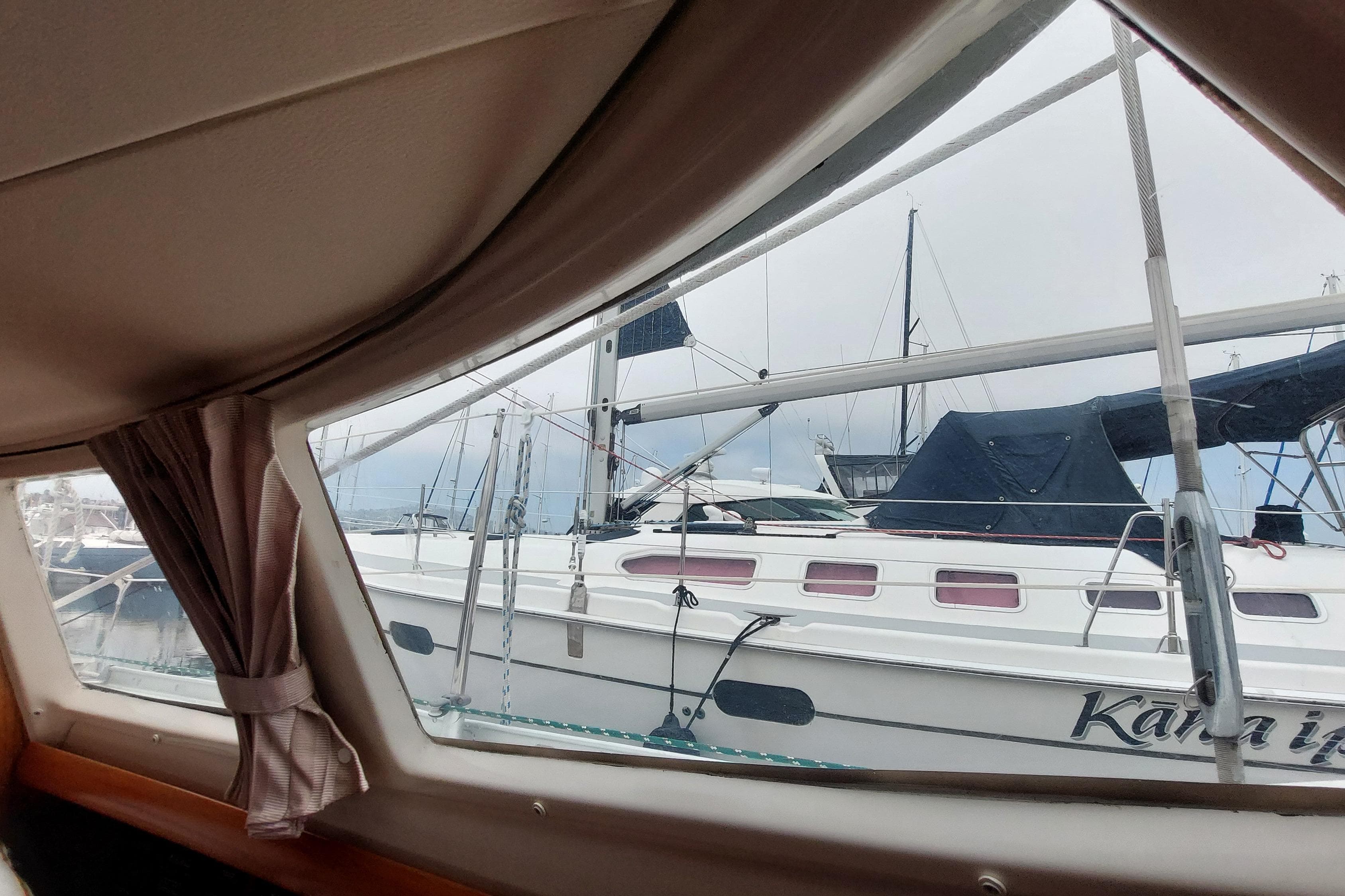 View from Jeanneau Sun Odyssey 43 DS (2002) cabin window, overlooking marina with sailboats.
