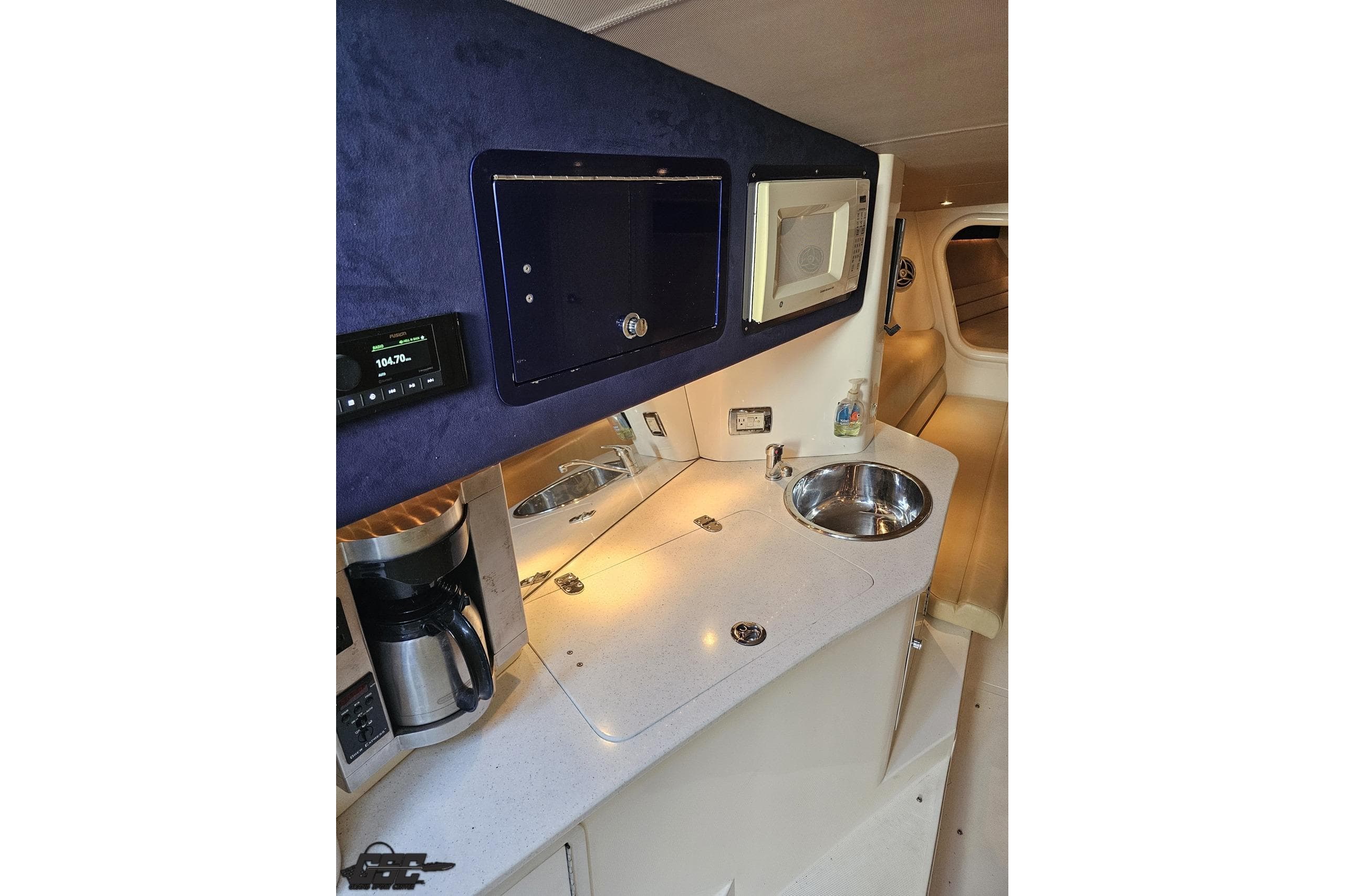 Interior of 2007 Hustler 41 Razor boat with kitchenette, sink, and microwave.