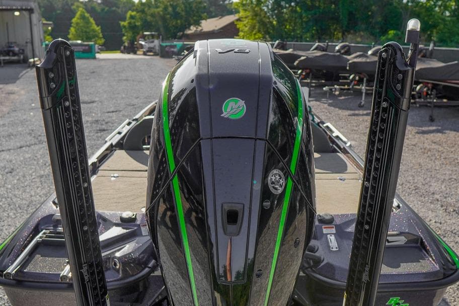2023 Bass Cat Puma STS boat with sleek black and green design, rear view.