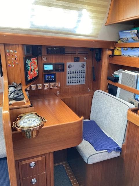2019 Hallberg-Rassy 44 yacht interior with navigation station and control panel.