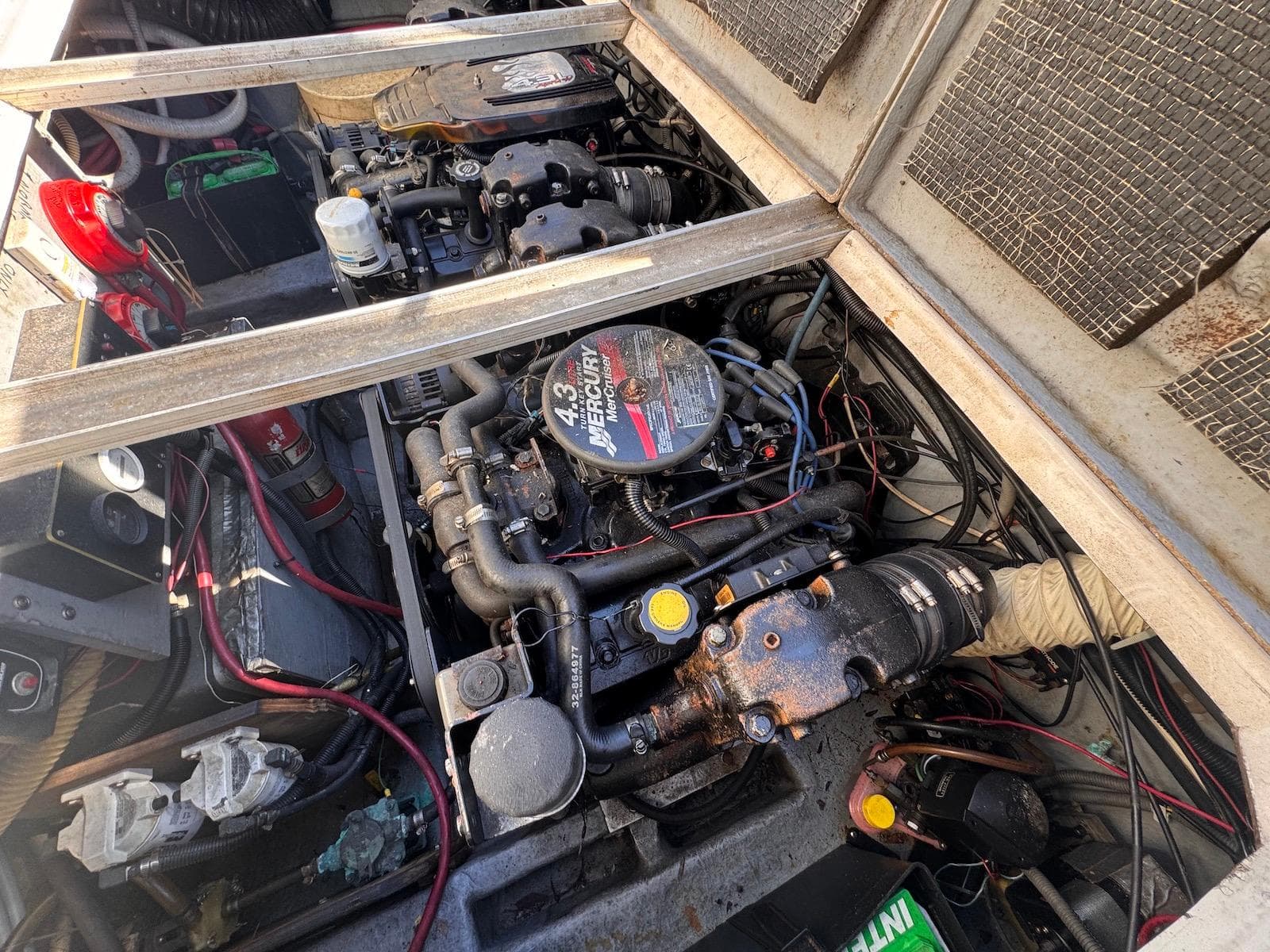 Engine compartment of a 1988 Sea Ray 265 Sedan Bridge boat, showing detailed mechanical components.